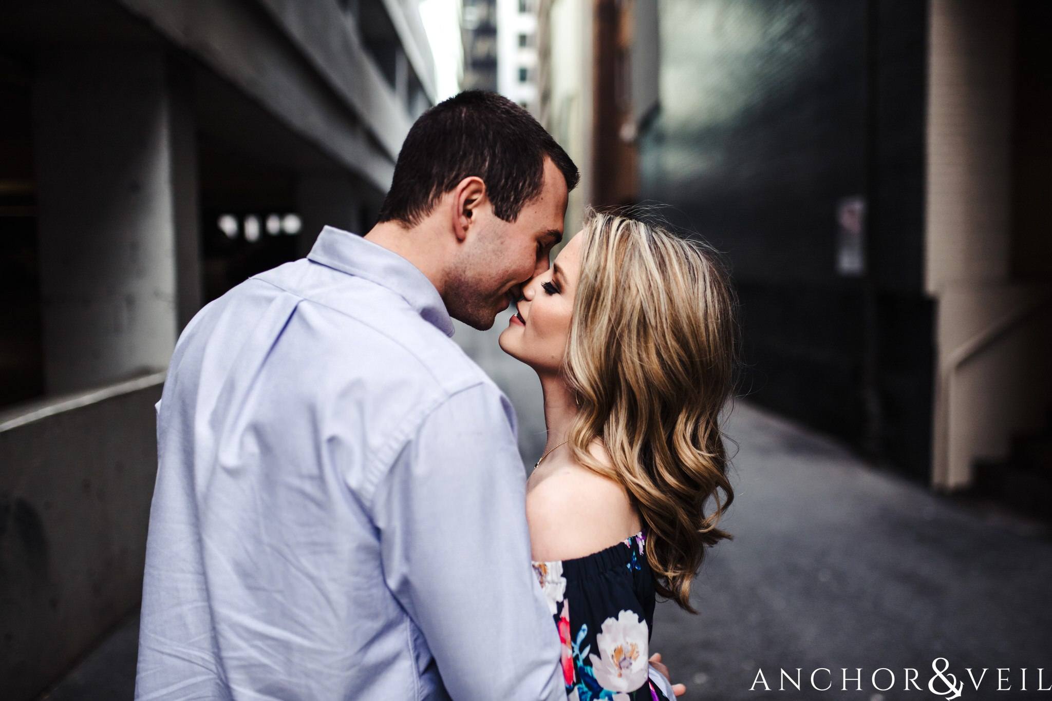 in the alley during their Uptown Charlotte Engagment Session The Green 1