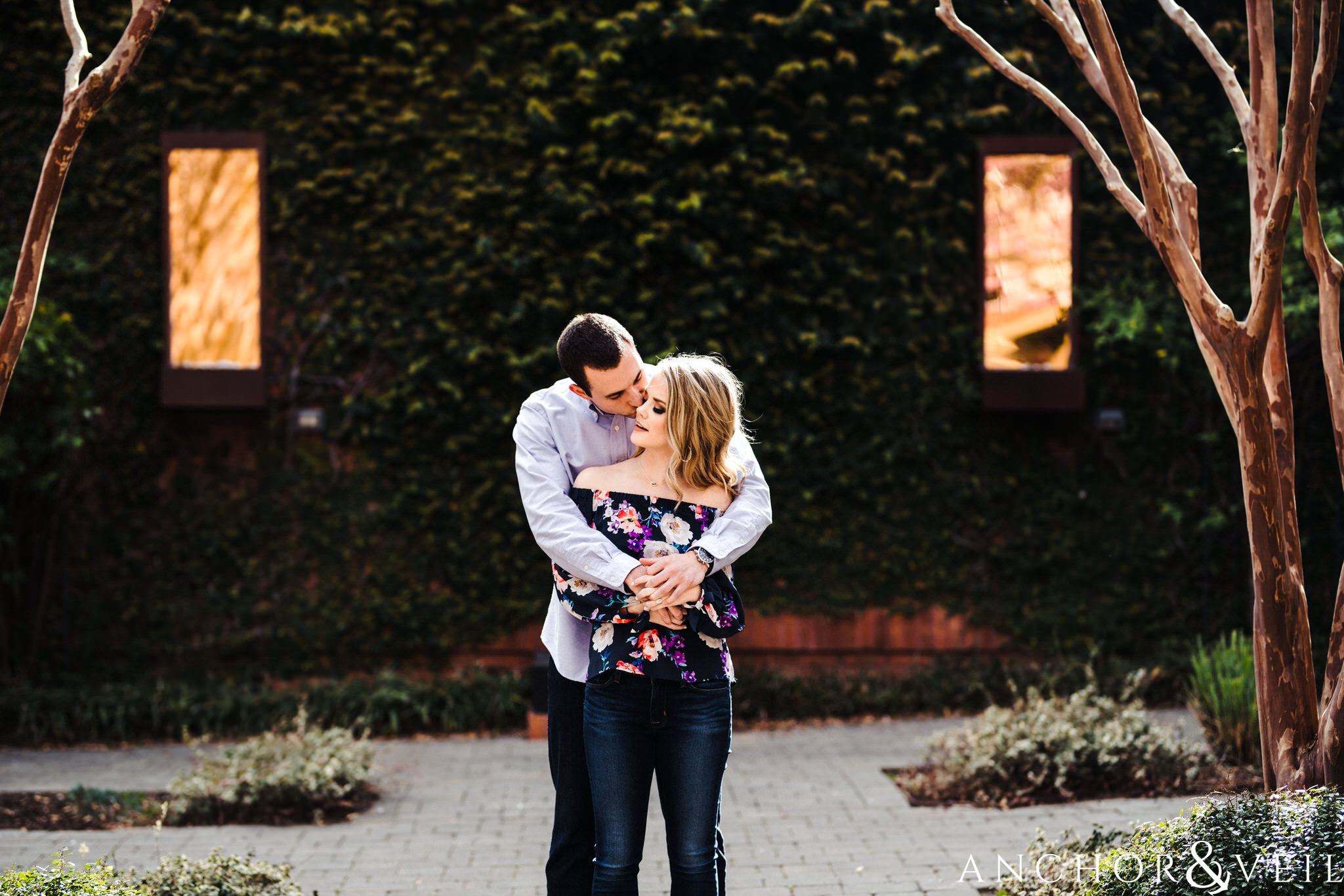 hugging tight during their Uptown Charlotte Engagment Session The Green 1