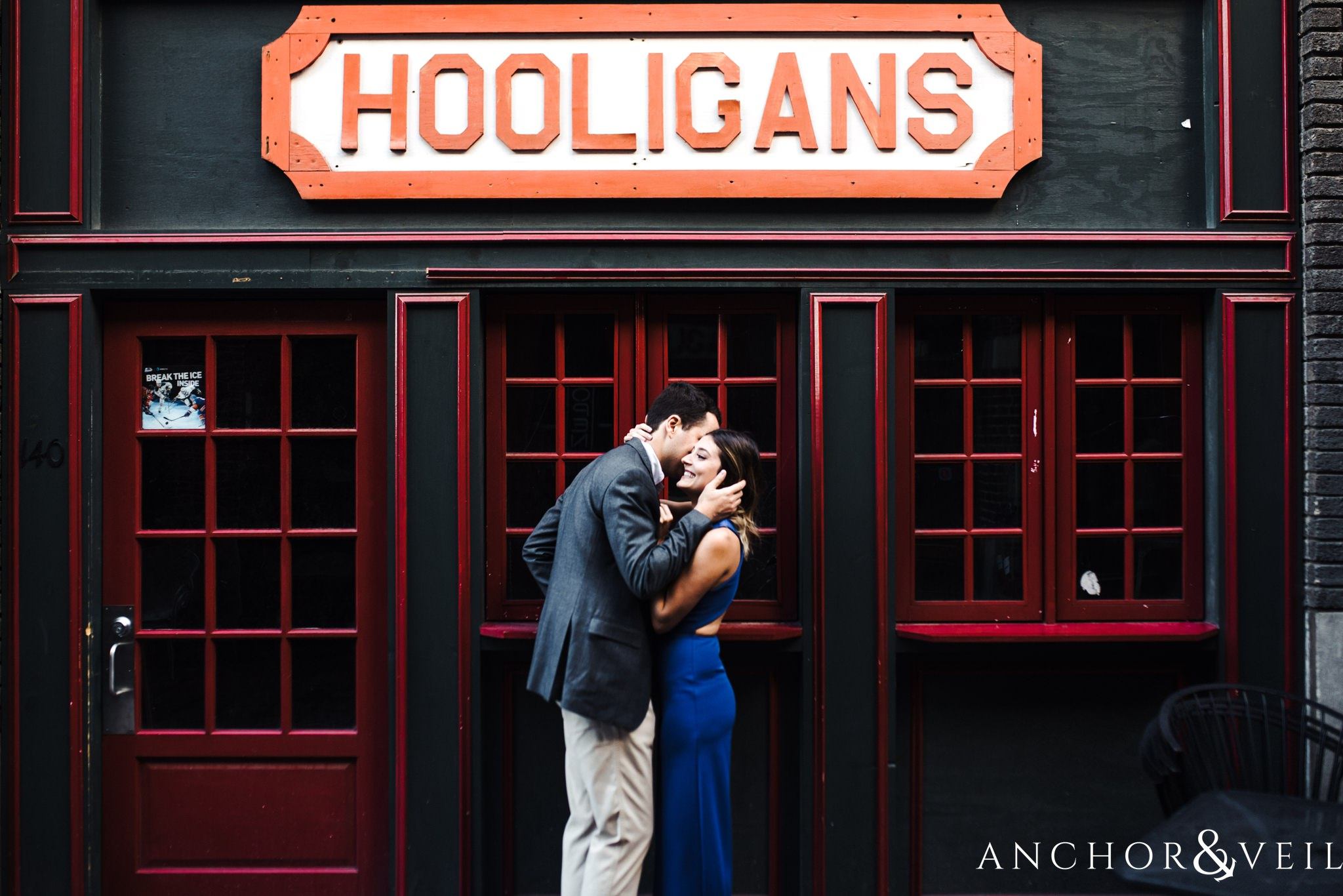 under the sign during the Uptown Charlotte Sycamore Brewery Engagement Session