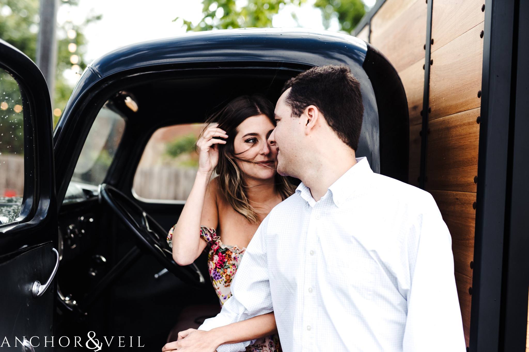picking up hair when its blowing during the Uptown Charlotte Sycamore Brewery Engagement Session