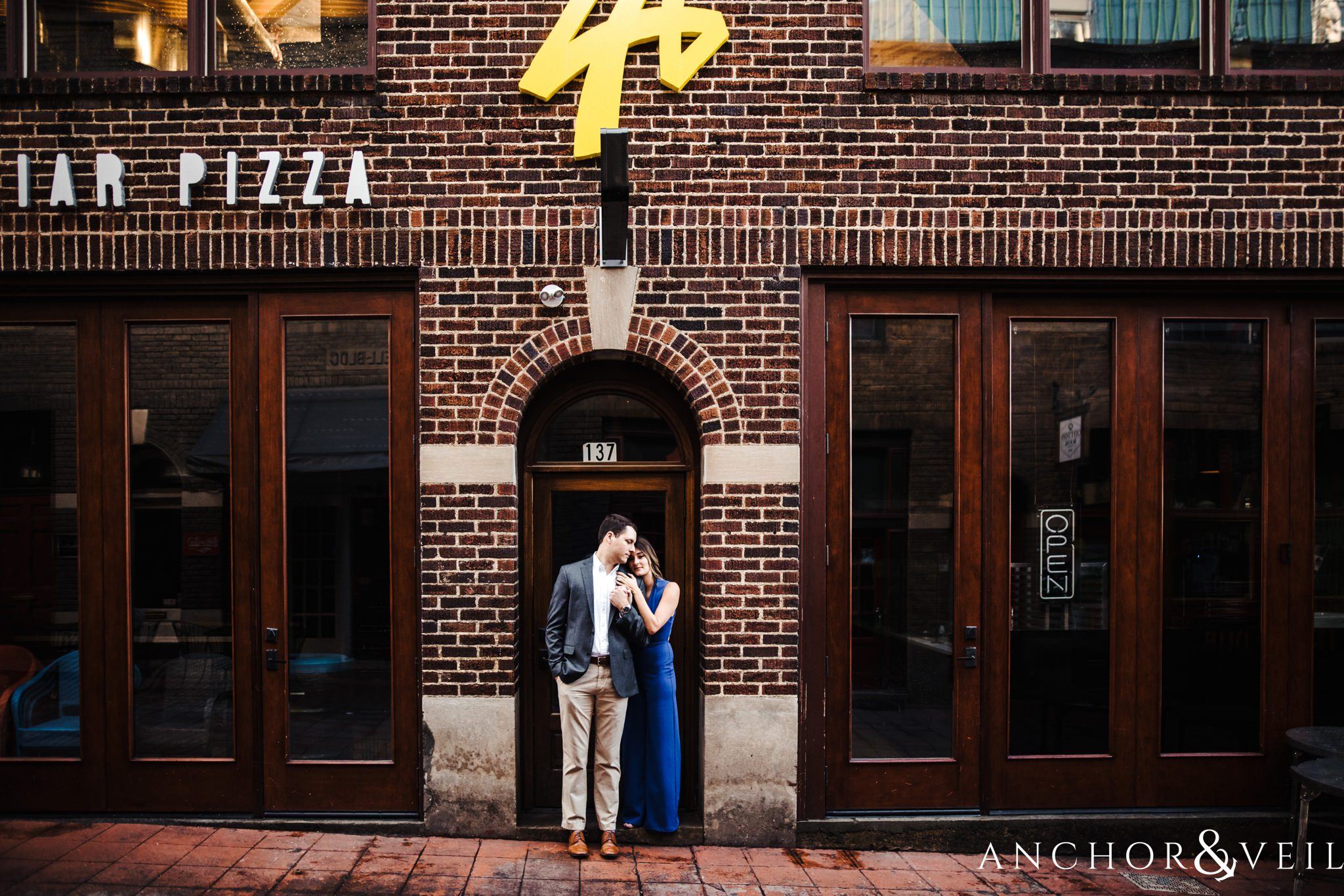 holding tight during the Uptown Charlotte Sycamore Brewery Engagement Session