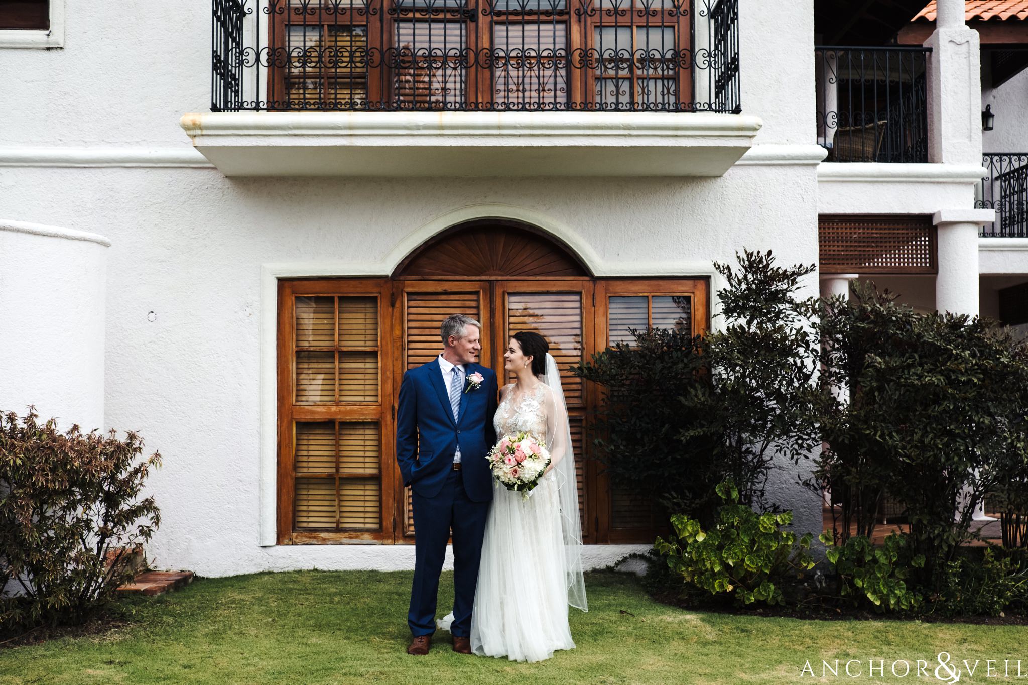 bride and groom in front of the window