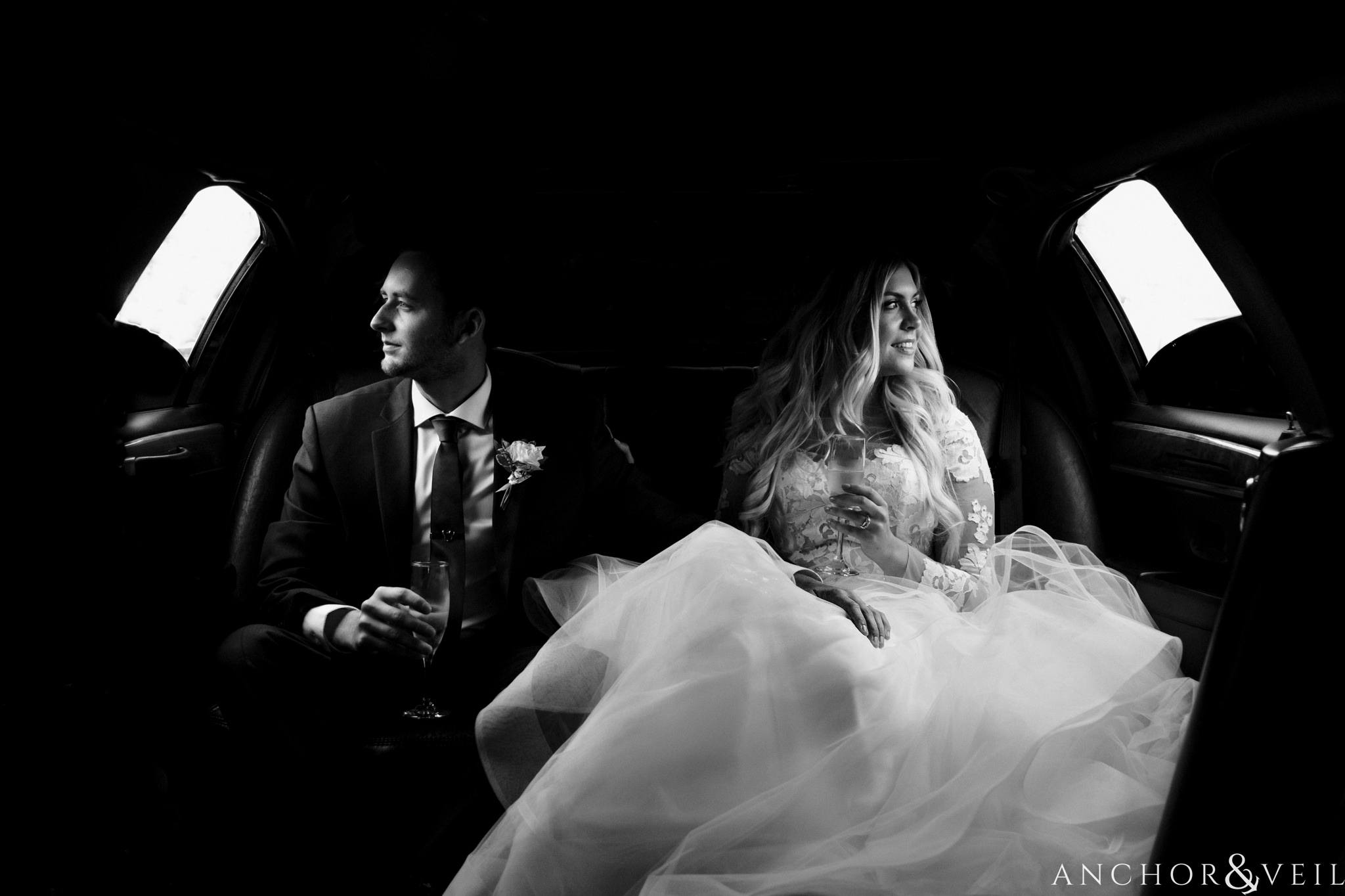 bride and groom sitting in the limo together