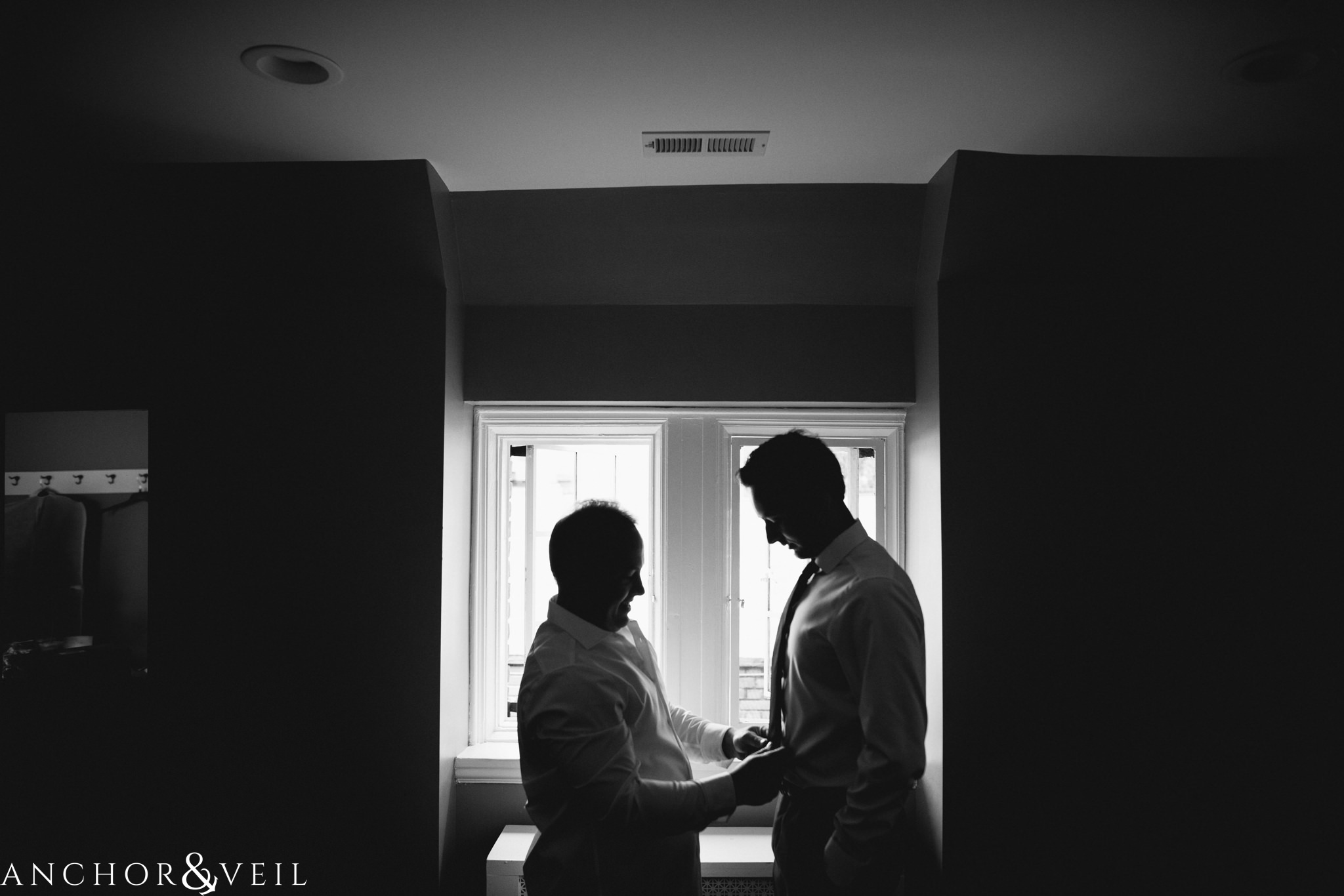 groom and father getting married with silhouette 