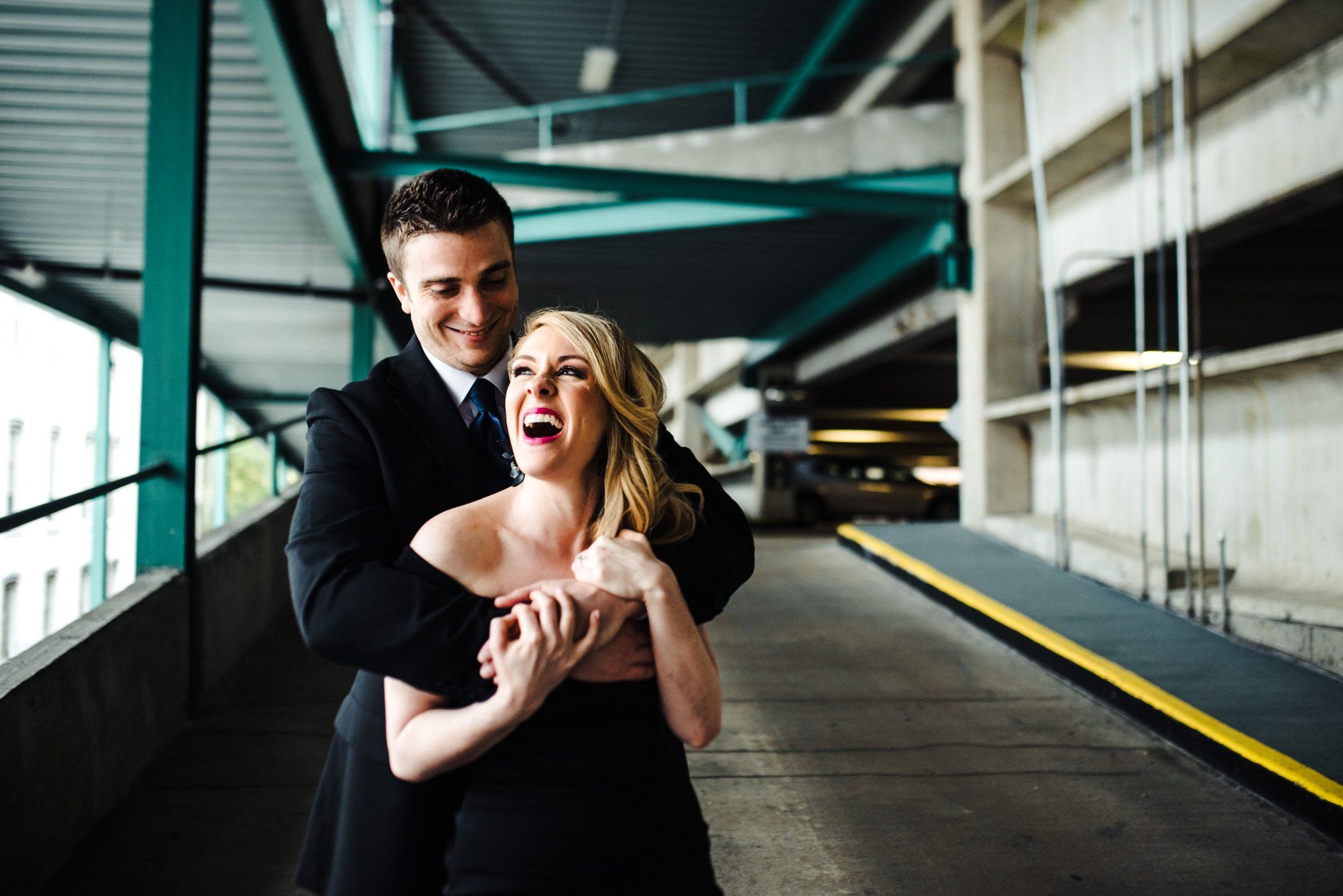 A portrait of a sweet and joyous expression of love in a parking deck of their Downtown Richmond Engagement Session