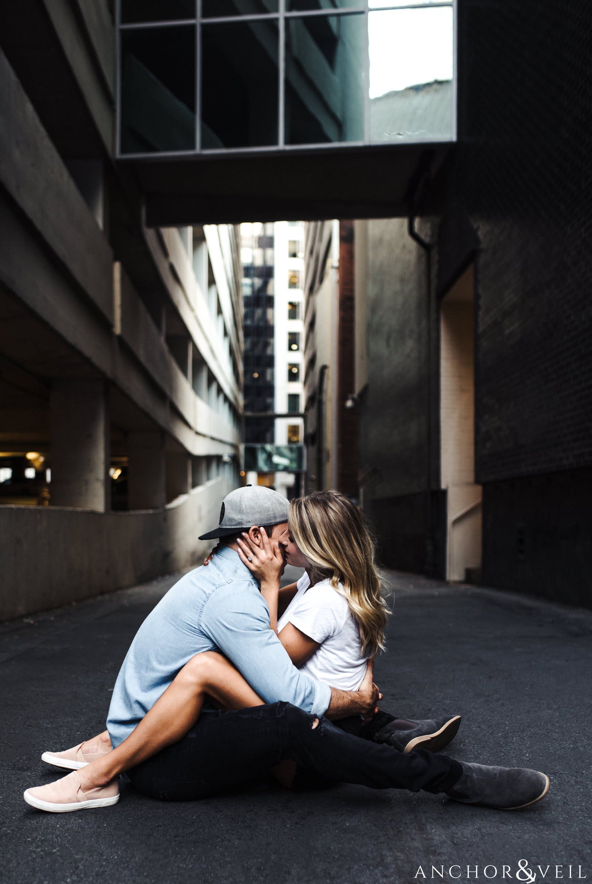 kissing his cheek in the alley uptown Charlotte engagement session