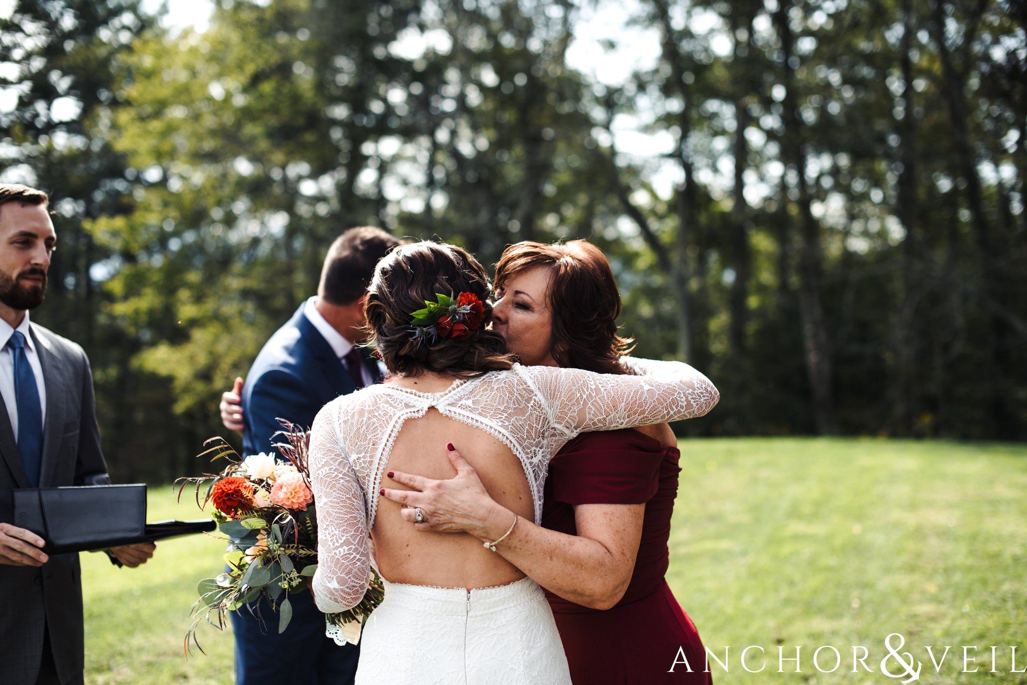 mom kissing daughter during her The Venue Wedding in Asheville