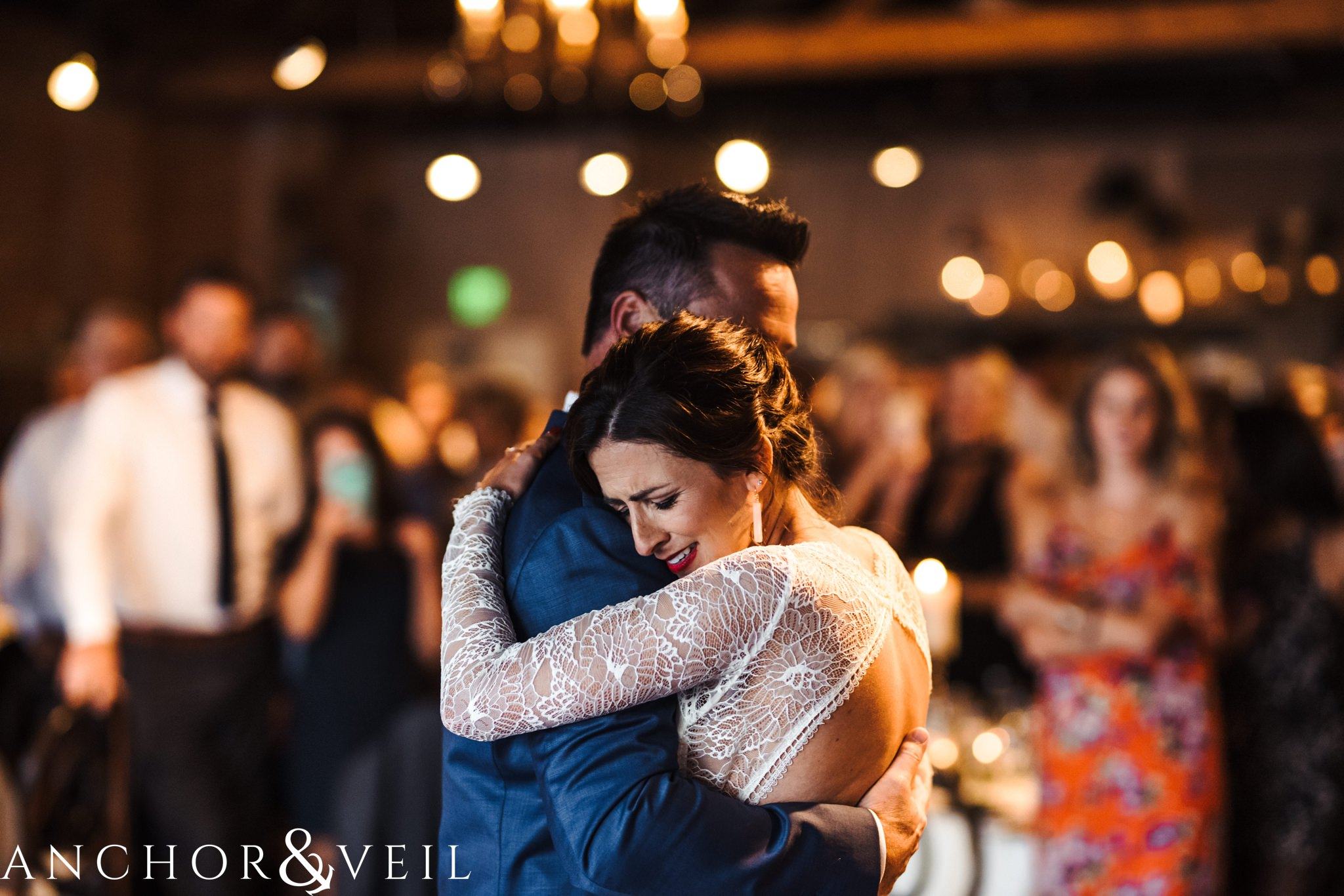 holding tight during the first dance during her The Venue Wedding in Asheville
