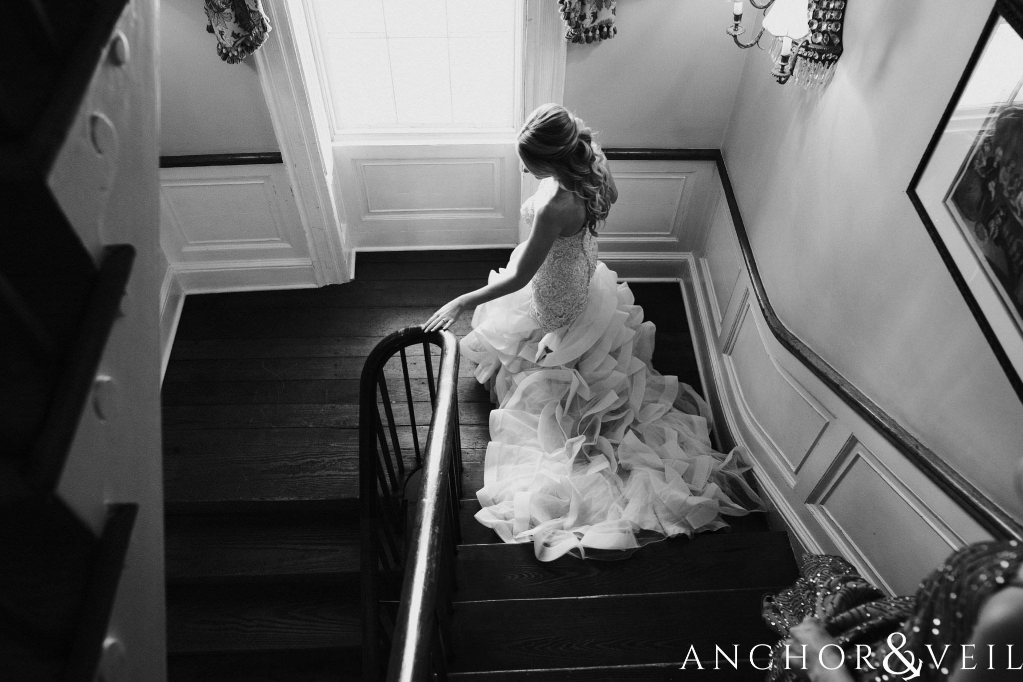 bride walking down the stairs during their William Aiken house Wedding in Charleston Sc