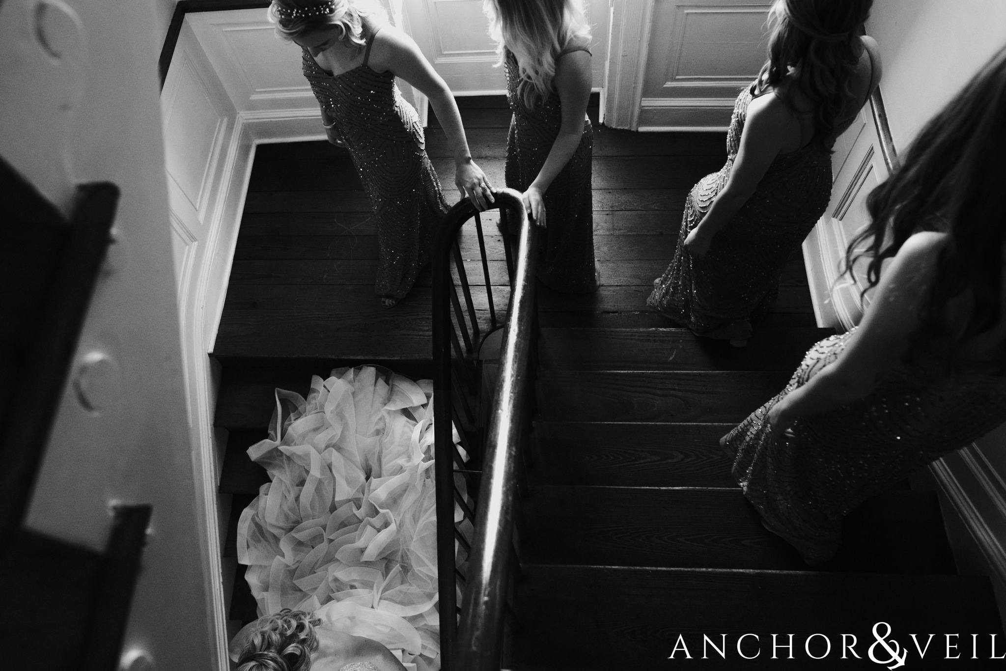 bride and bridesmaids walking down the stairs during their William Aiken house Wedding in Charleston Sc