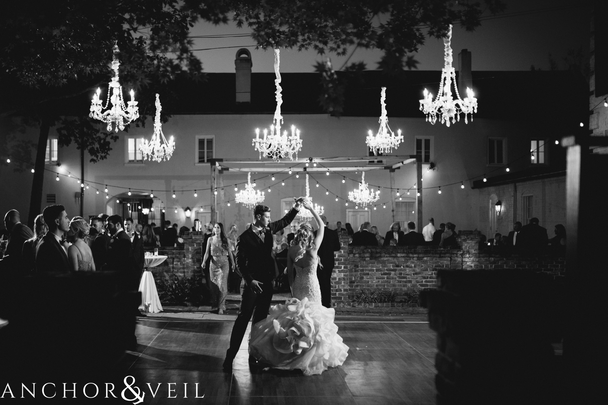 first dance and chandeliers during their William Aiken house Wedding in Charleston Sc