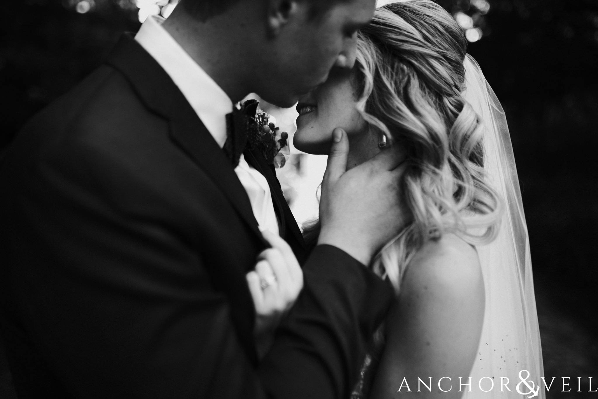 kissing her cheek during their William Aiken house Wedding in Charleston Sc