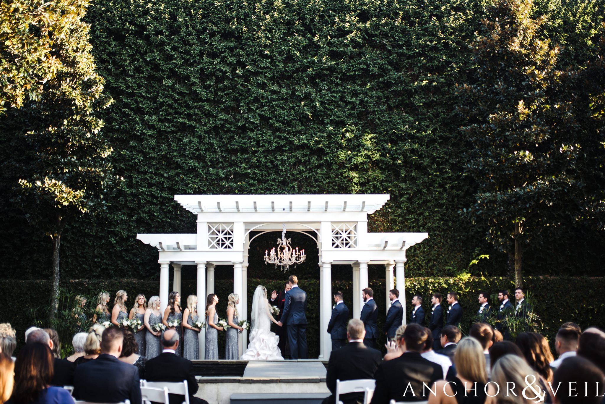 ceremony with green Ivey wall during their William Aiken house Wedding in Charleston Sc