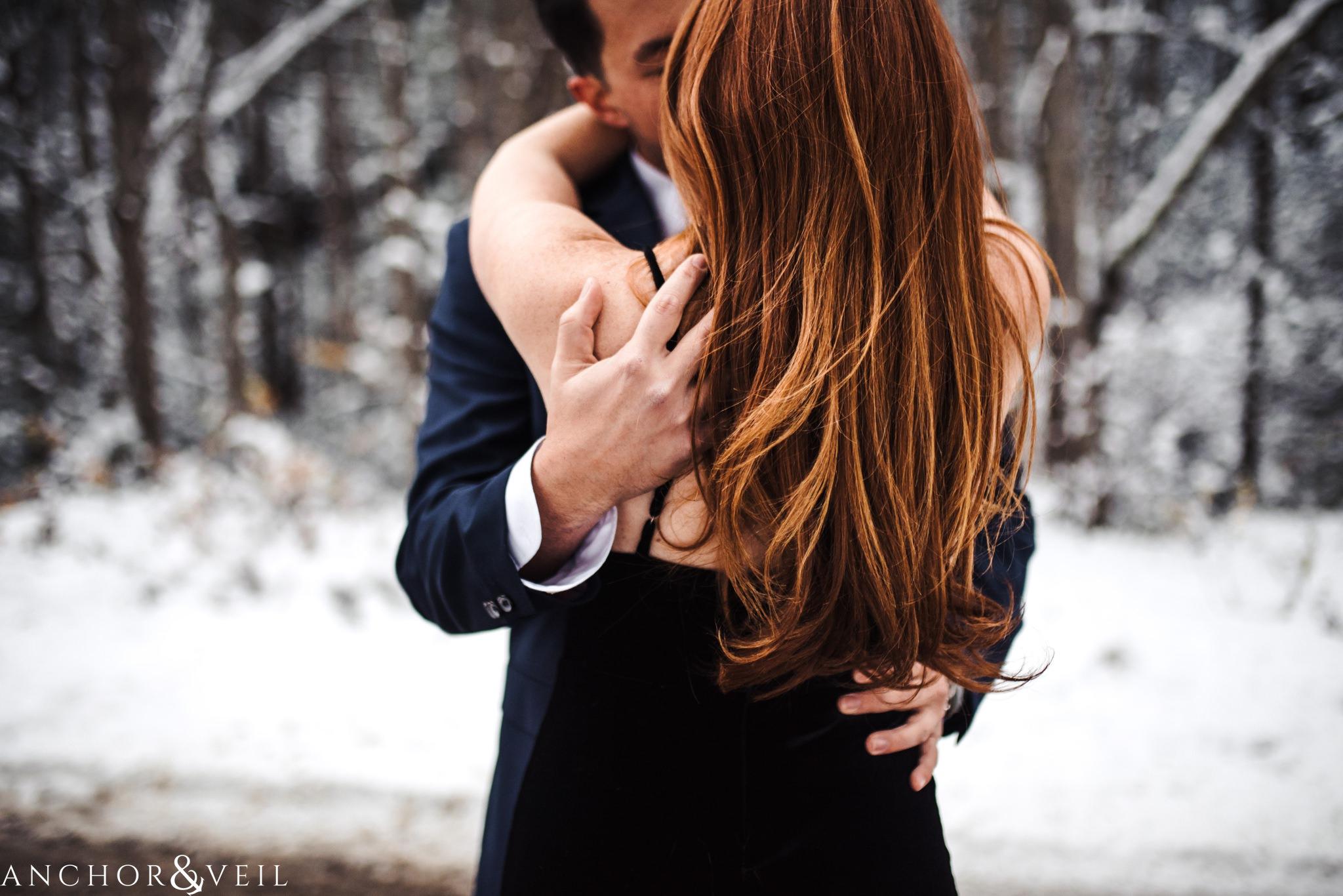 sweet embrace during their Snowy Asheville Engagement Session