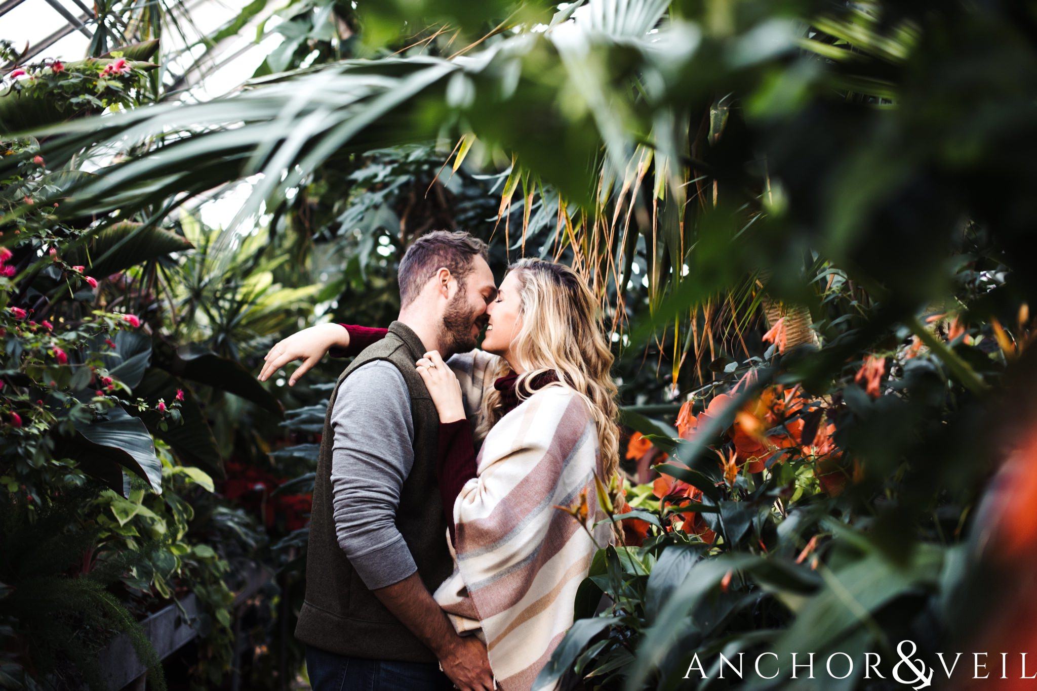IN the greenhouse garden during their Snowy Biltmore Engagement Session