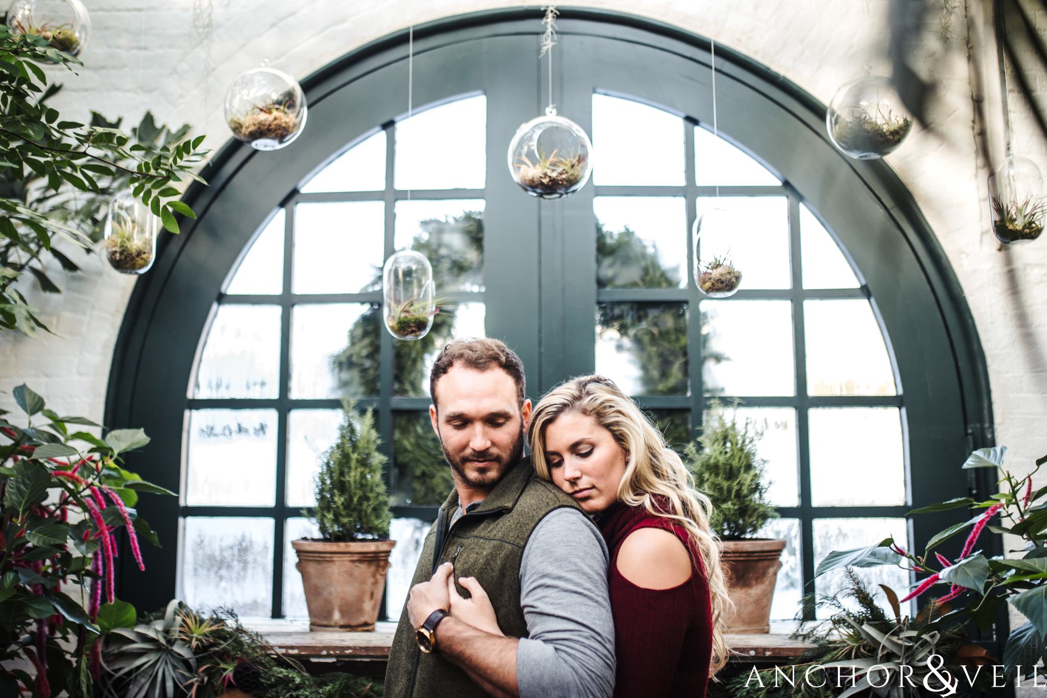holding under the terrariums during their Snowy Biltmore Engagement Session