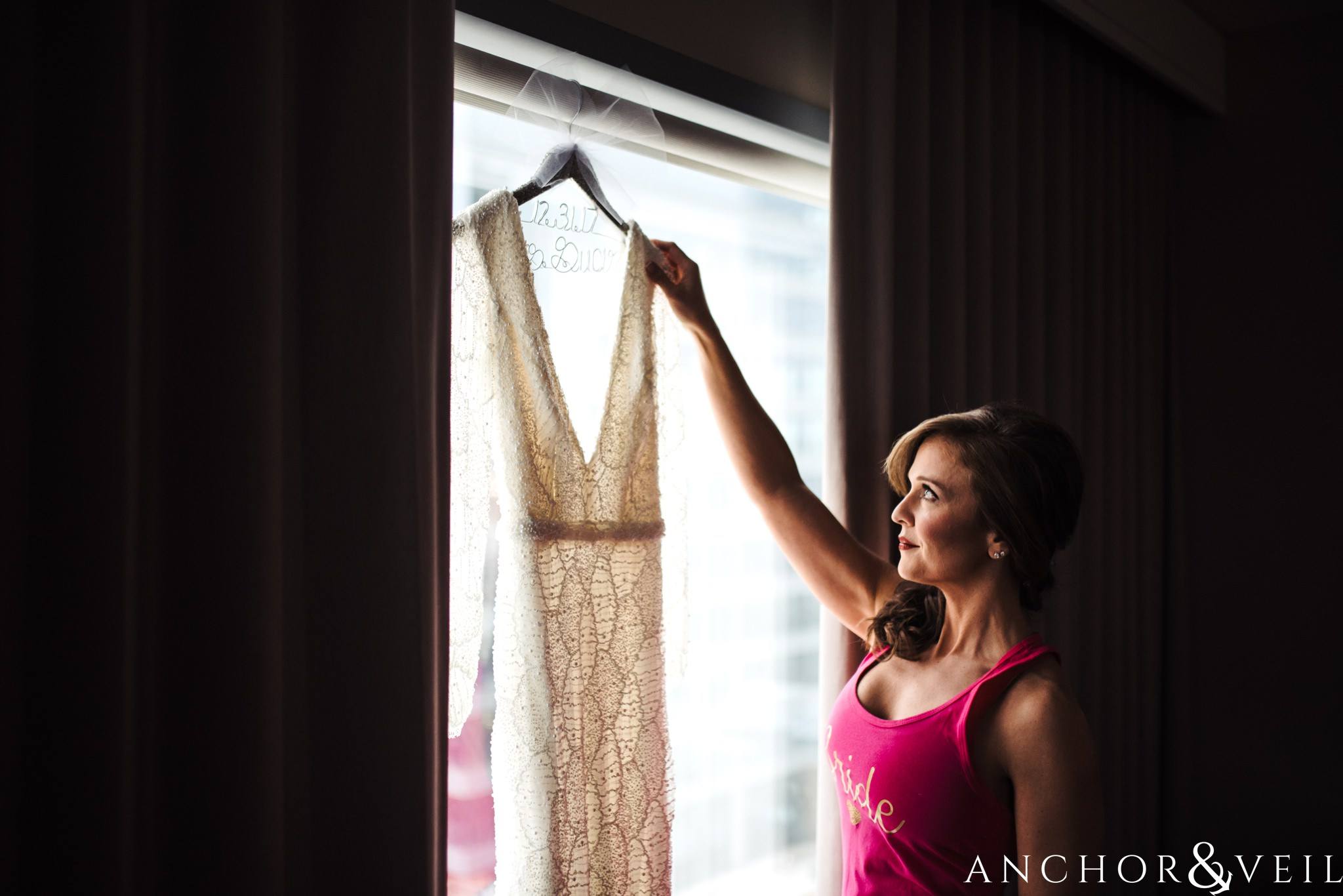 bride getting dress during their New Years Even uptown Charlotte Wedding