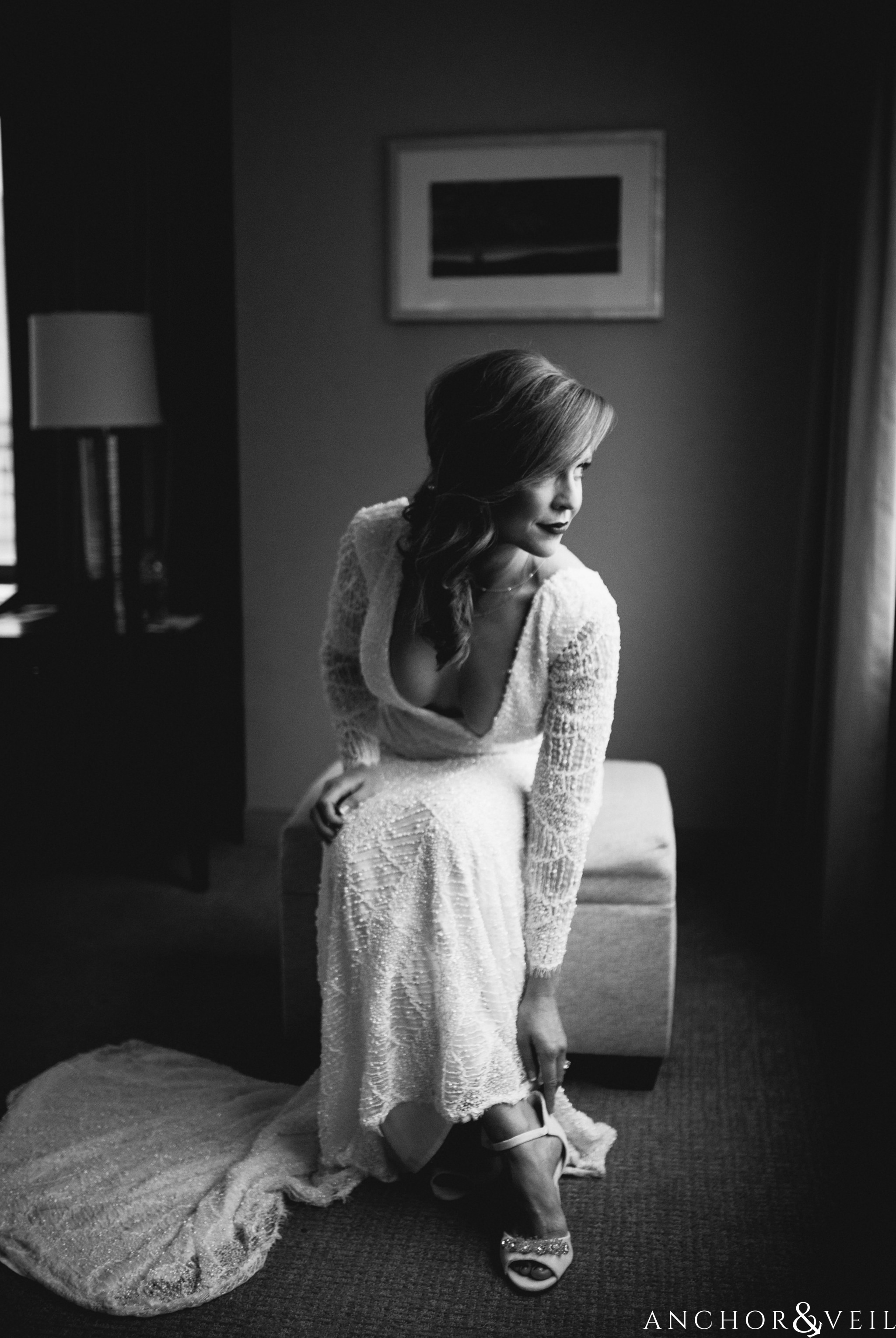 bride putting on dress during their New Years Even uptown Charlotte Wedding