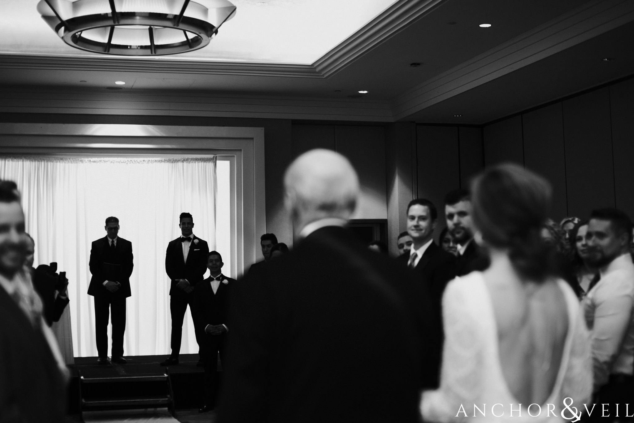 bride walking down the aisle during their New Years Even uptown Charlotte Wedding