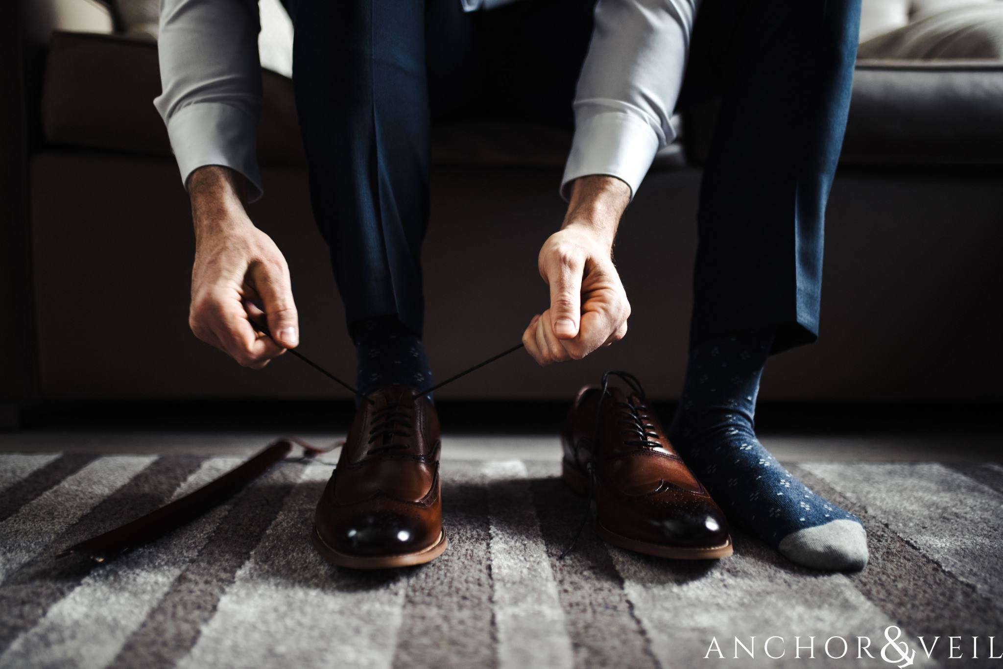 groom tying his shoes during their Downtown Asheville Wedding 