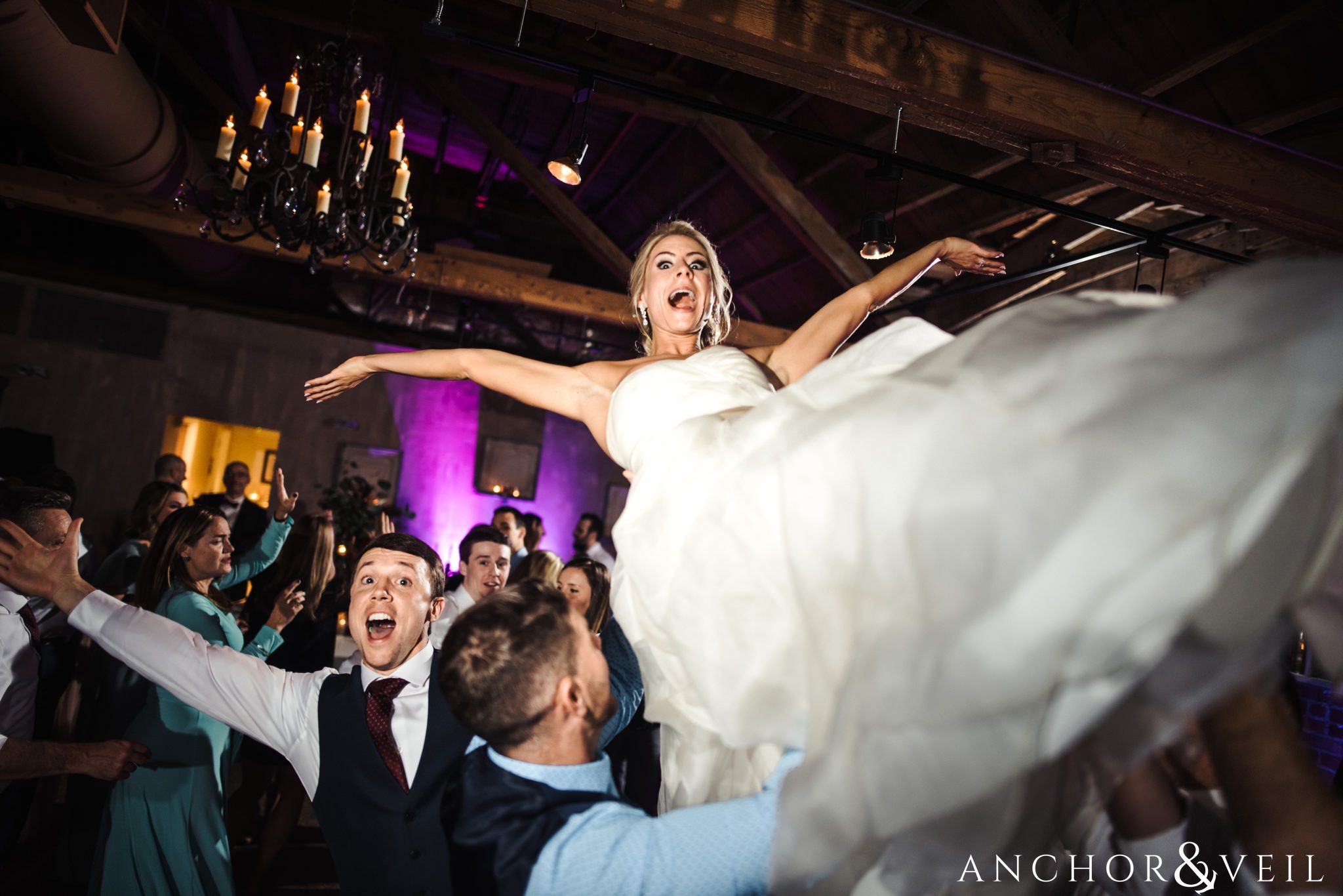 tossing the bride during their Downtown Asheville Wedding