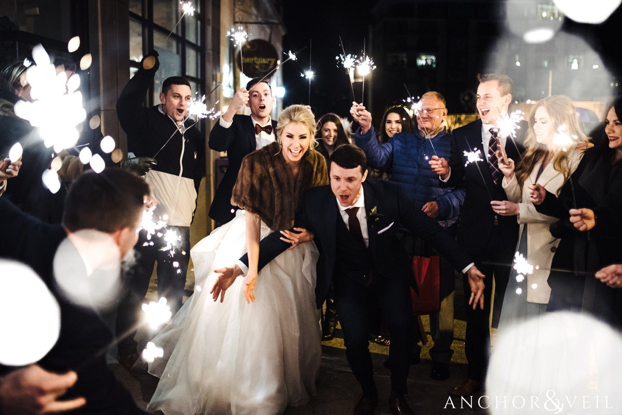 fun sparkler exit during their Downtown Asheville Wedding