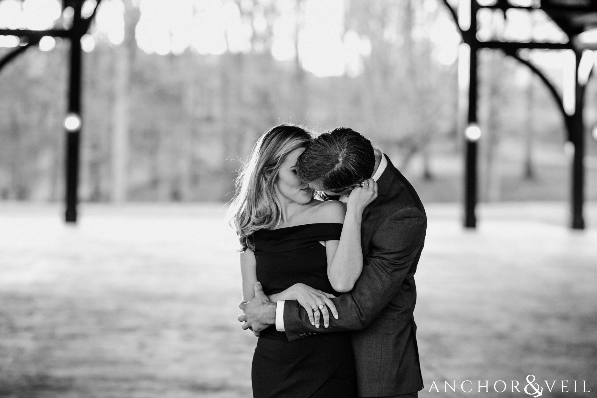holding him as he kisses her shoulder during their Dale Earnhardt Inc Engagement Session Mooresville