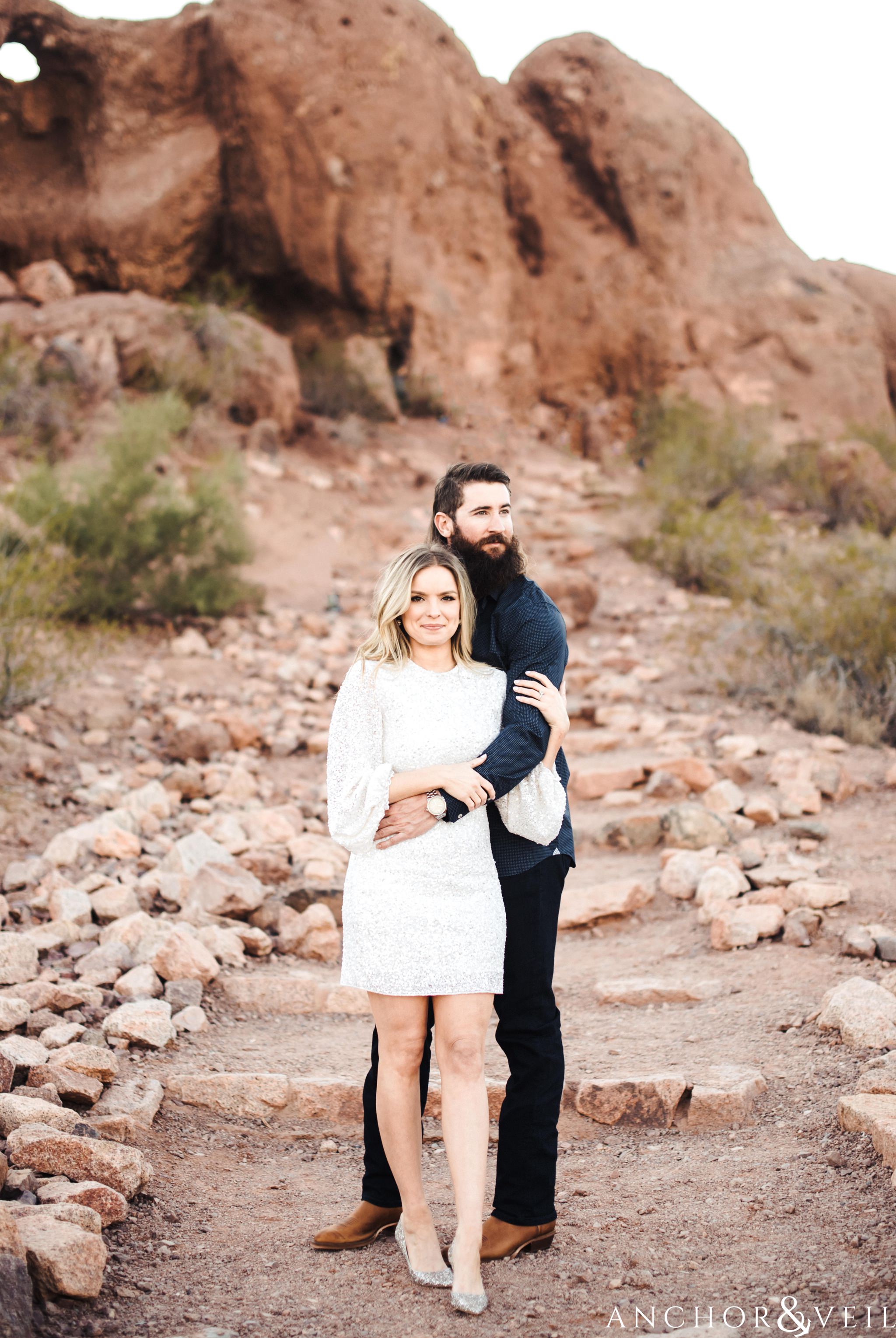 walking up to the hole in the rock during their spring training Arizona Papago park engagement session