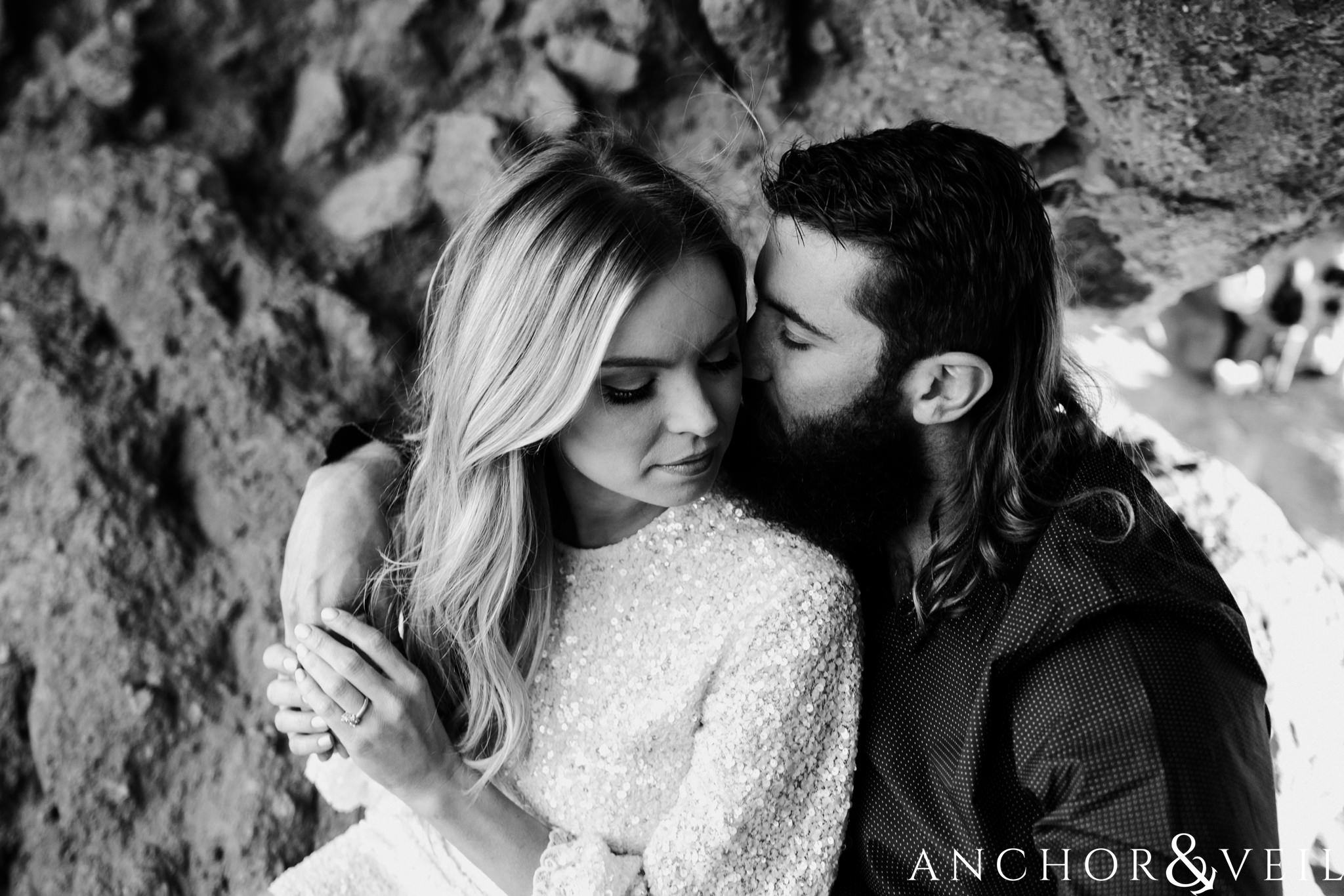 getting close in the hole in the rock during their spring training Arizona Papago park engagement session