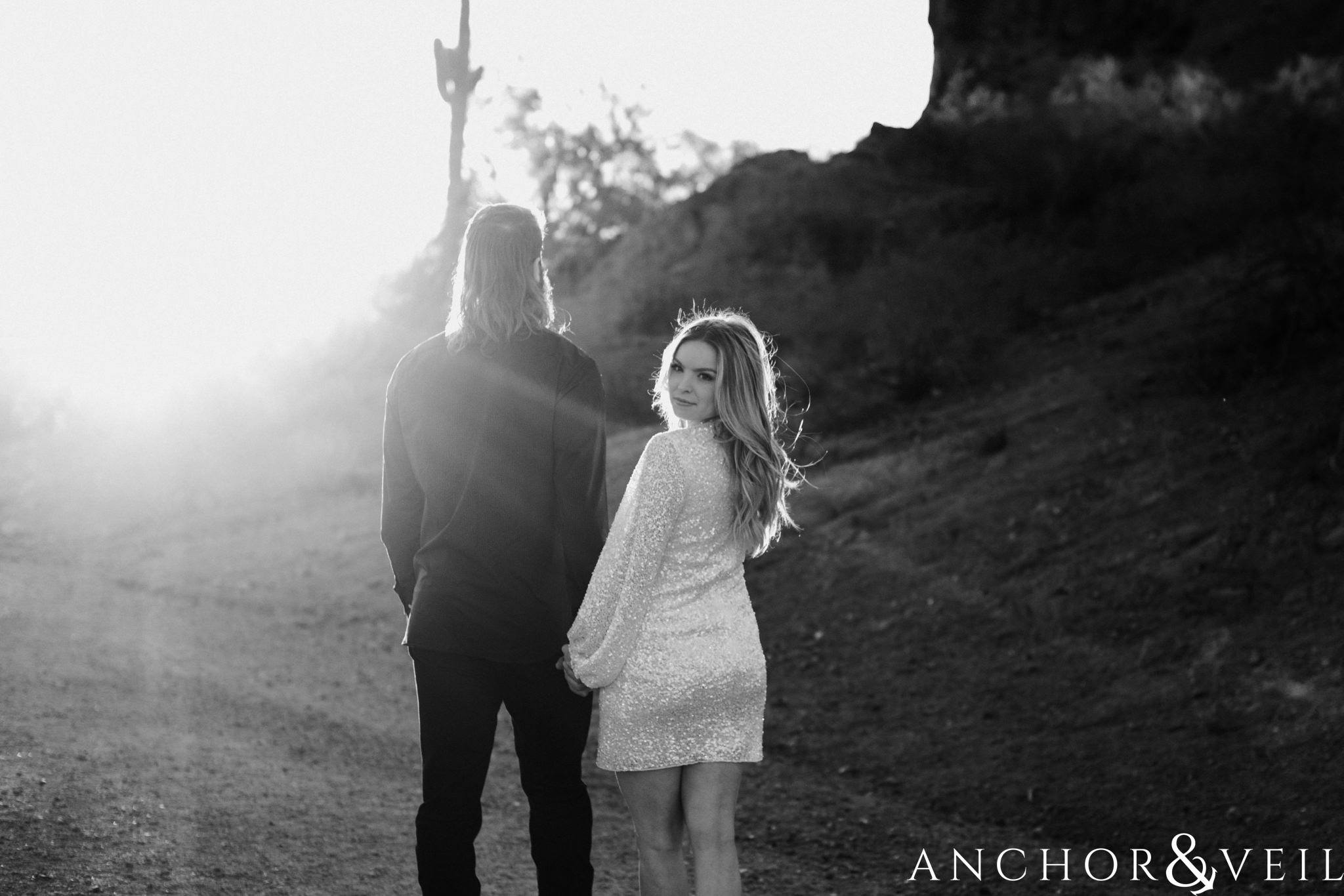 look back during their spring training Arizona Papago park engagement session