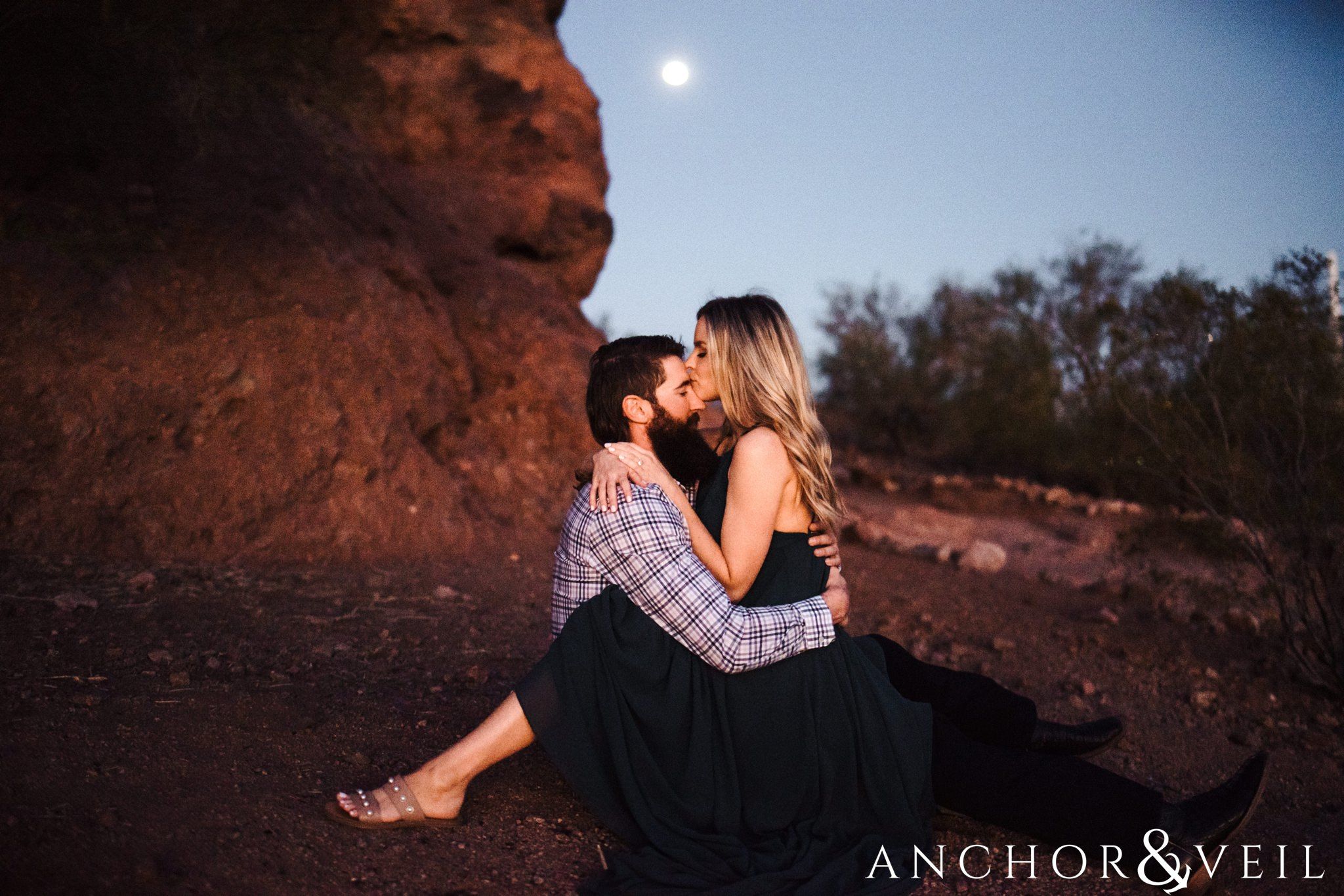 sitting under the moon during their spring training Arizona Papago park engagement session