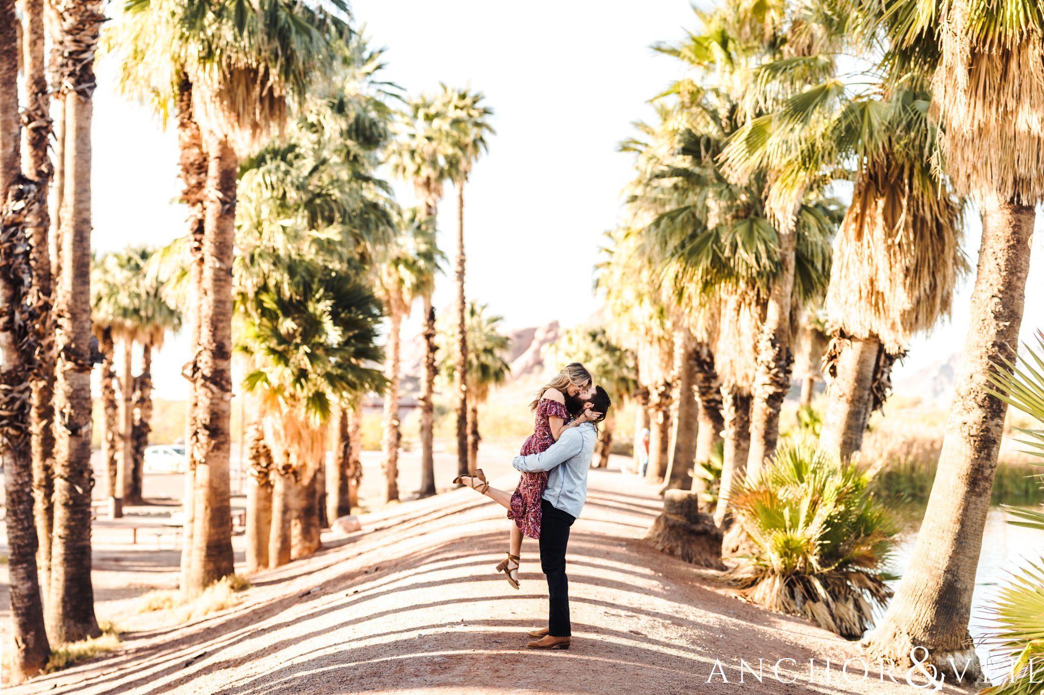 in between the trees during their spring training Arizona Papago park engagement session