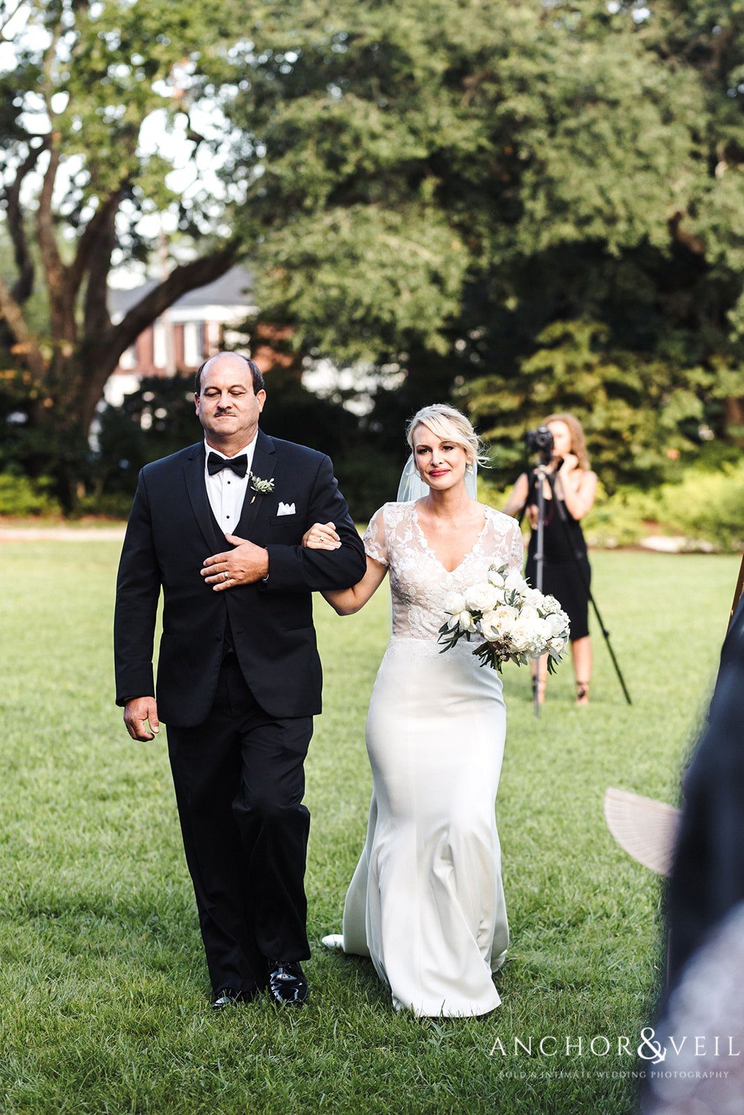The bride walking down the isle at the Lowndes Grove Plantation Wedding