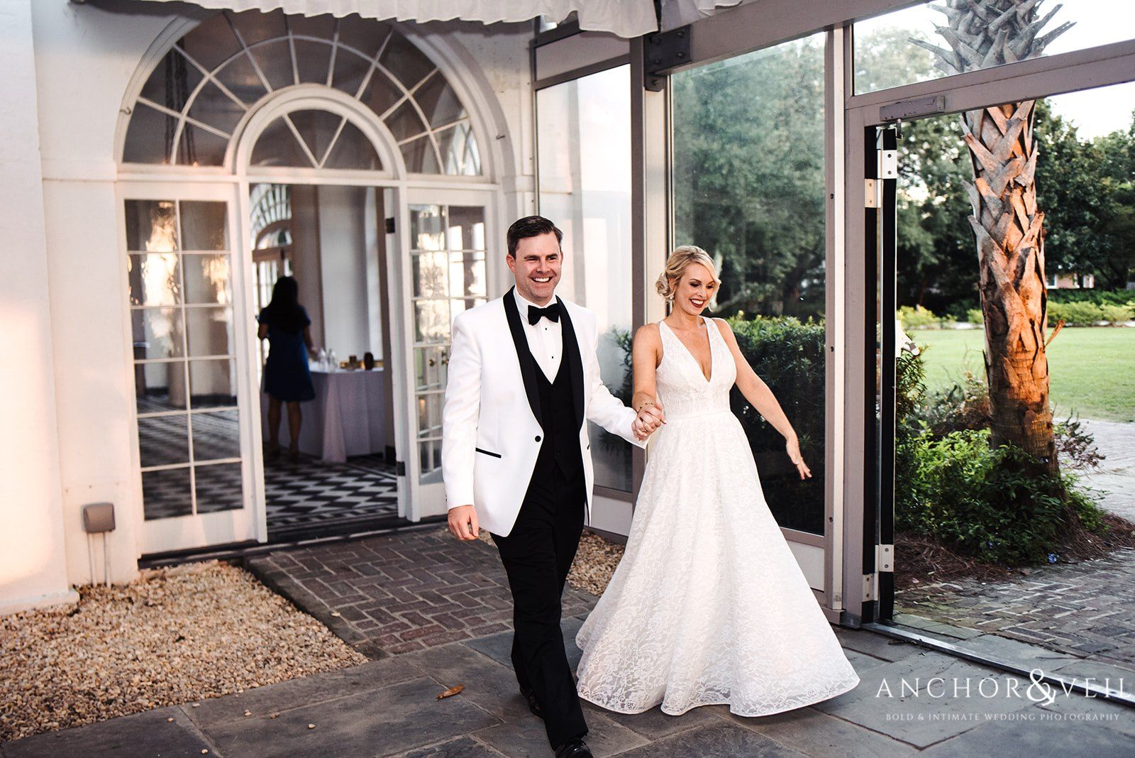The bride and groom entering the reception at the Lowndes Grove Plantation Wedding