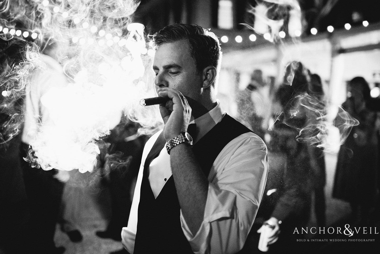 The groom enjoying a hand-rolled cigar at the Lowndes Grove Plantation Wedding