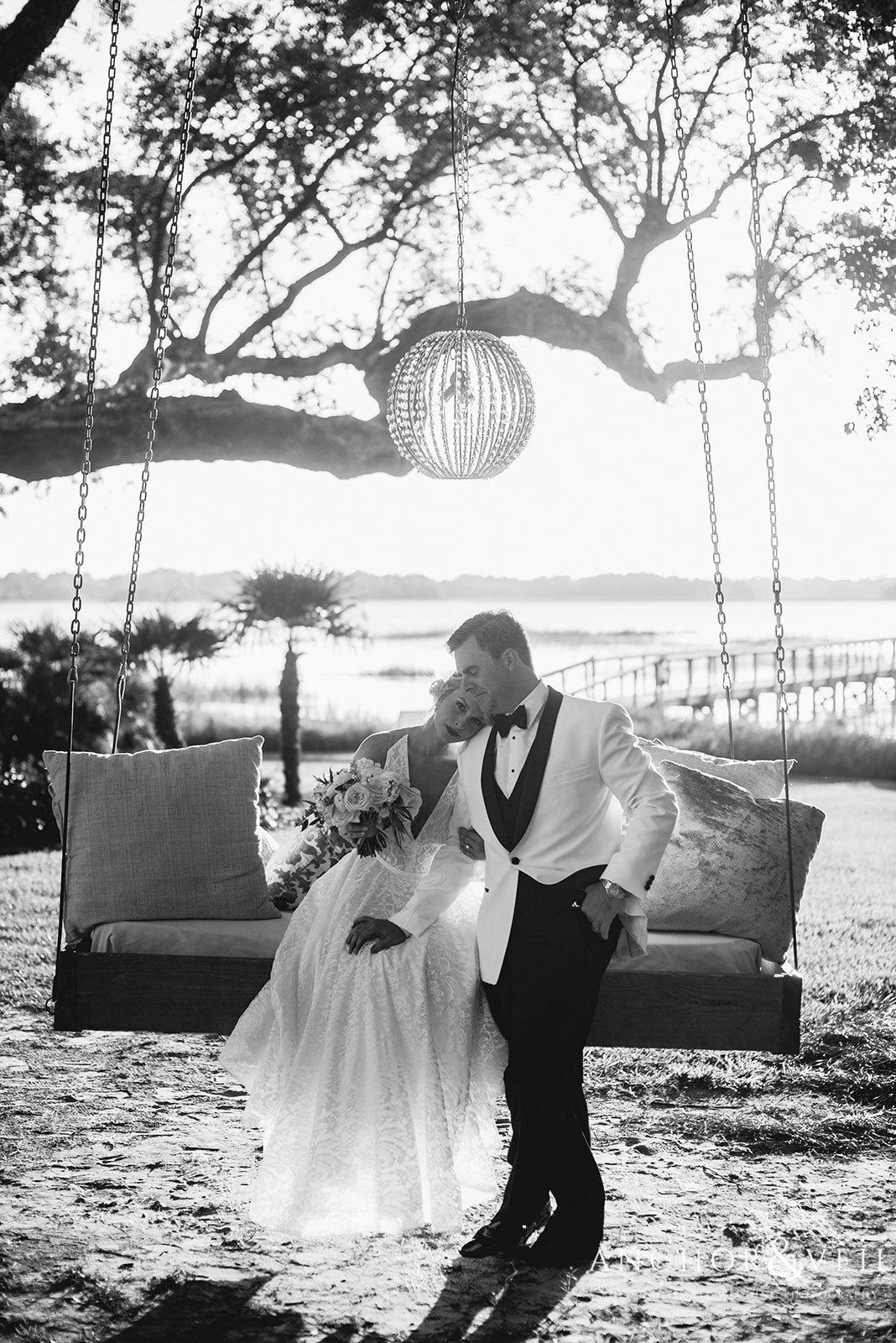 The bridge and groom on the swing in the garden at the Lowndes Grove Plantation Wedding