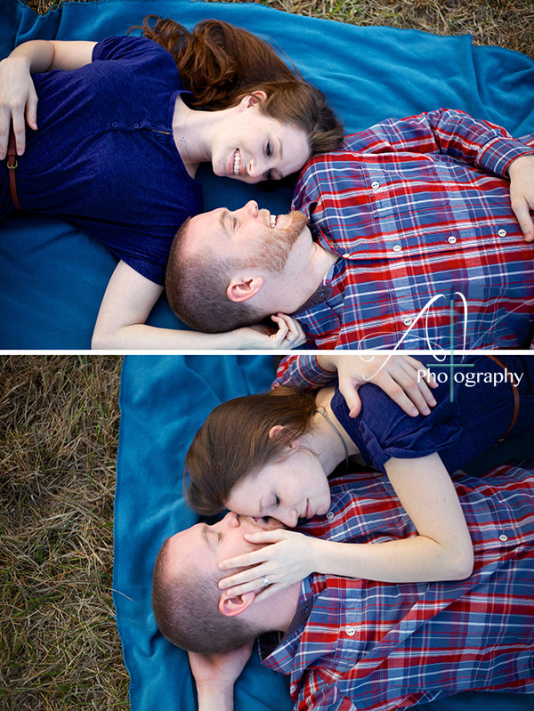 A couple share sweet and intimate moments while laying on a blanket in an open field during their Downtown Concord Engagement Session