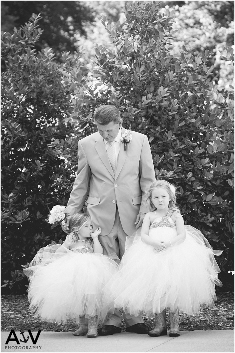 a sneaky photo taken of the Grandpa with his grandaughters after the Wedding ceremony at the winmock at kinderton in winston salem