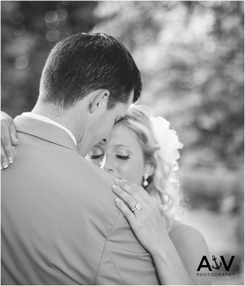 Bride and groom romantic over the shoulder picture with the ring at the winmock at kinderton in Winston Salem
