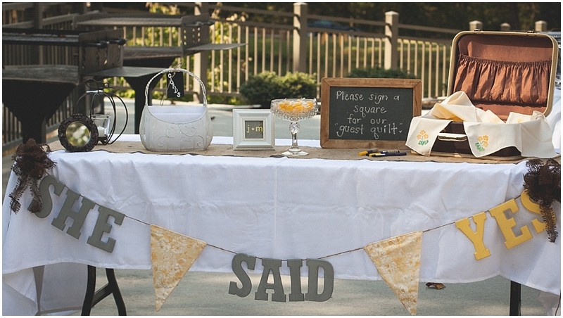 She said yes guest table at the country chic DIY wedding in Tanglewood park in Winston Salem Clemmons North Carolina