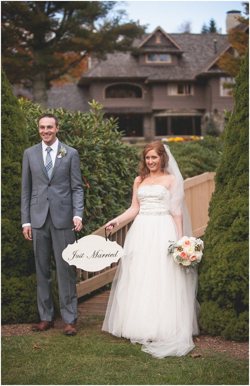 Bride and groom with the just married sign at the Waterfront wedding at the chetola resort and spa in Blowing rock North Carolina