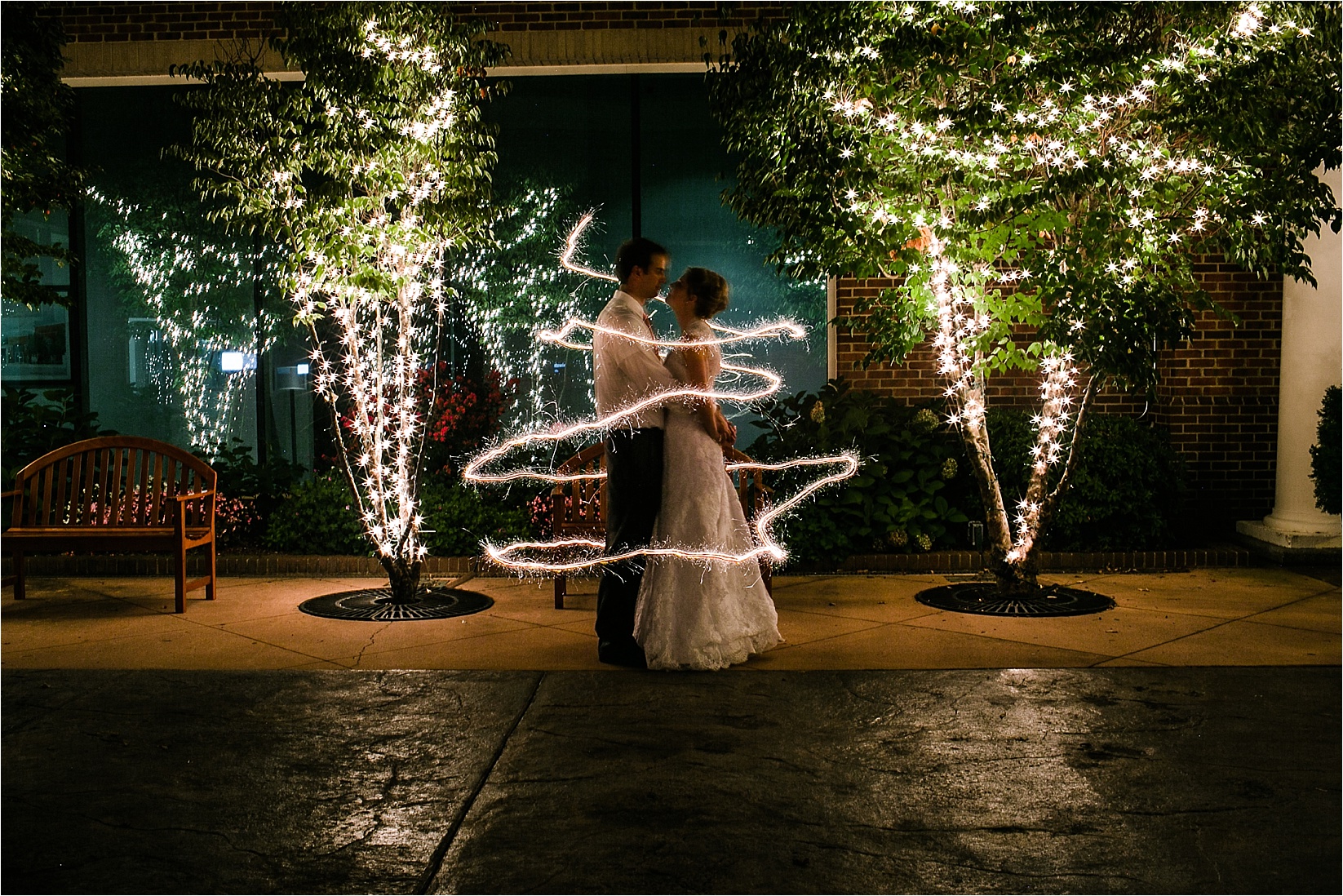 long exposure sparklers circled around bride and groom at the davidson college chapel wedding in Davidson north Carolina and the Charles mack citizen center wedding and reception