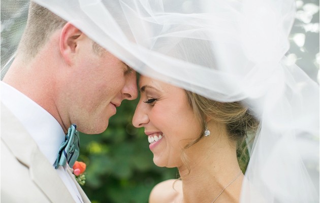 under the veil smiles during their wedding at the Historic Rural Hill wedding ceremony and reception in Huntersville nc