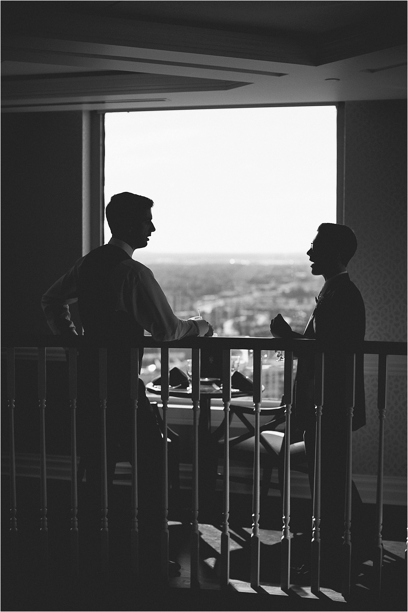 silhouettes of the groomsmen in front of the window at the Charlotte City Club wedding in charlotte North Carolina