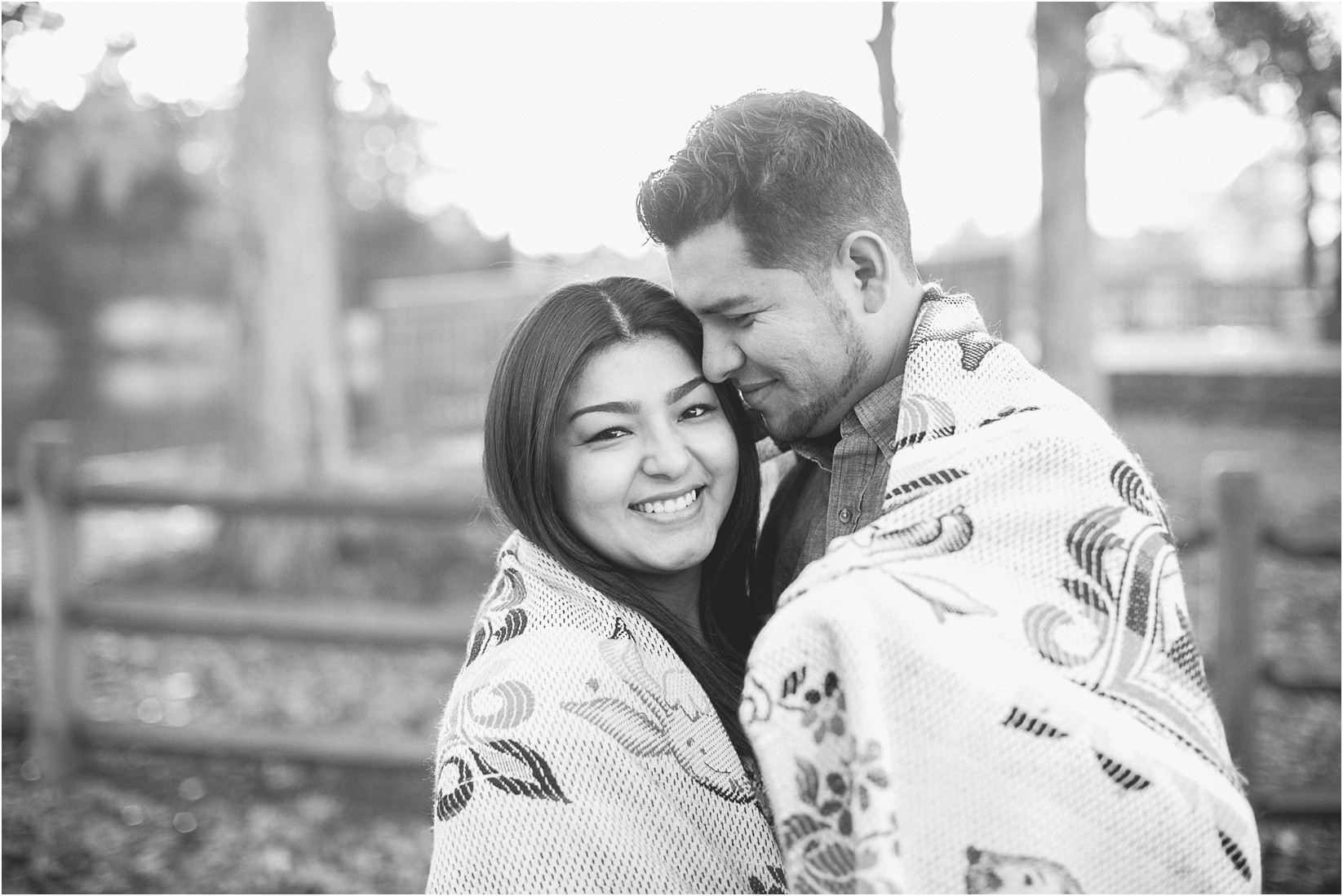 Cuddled and wrapped up in a blanket during the Mcdowell Nature Preserve Engagement Session near lake Wylie north carolina