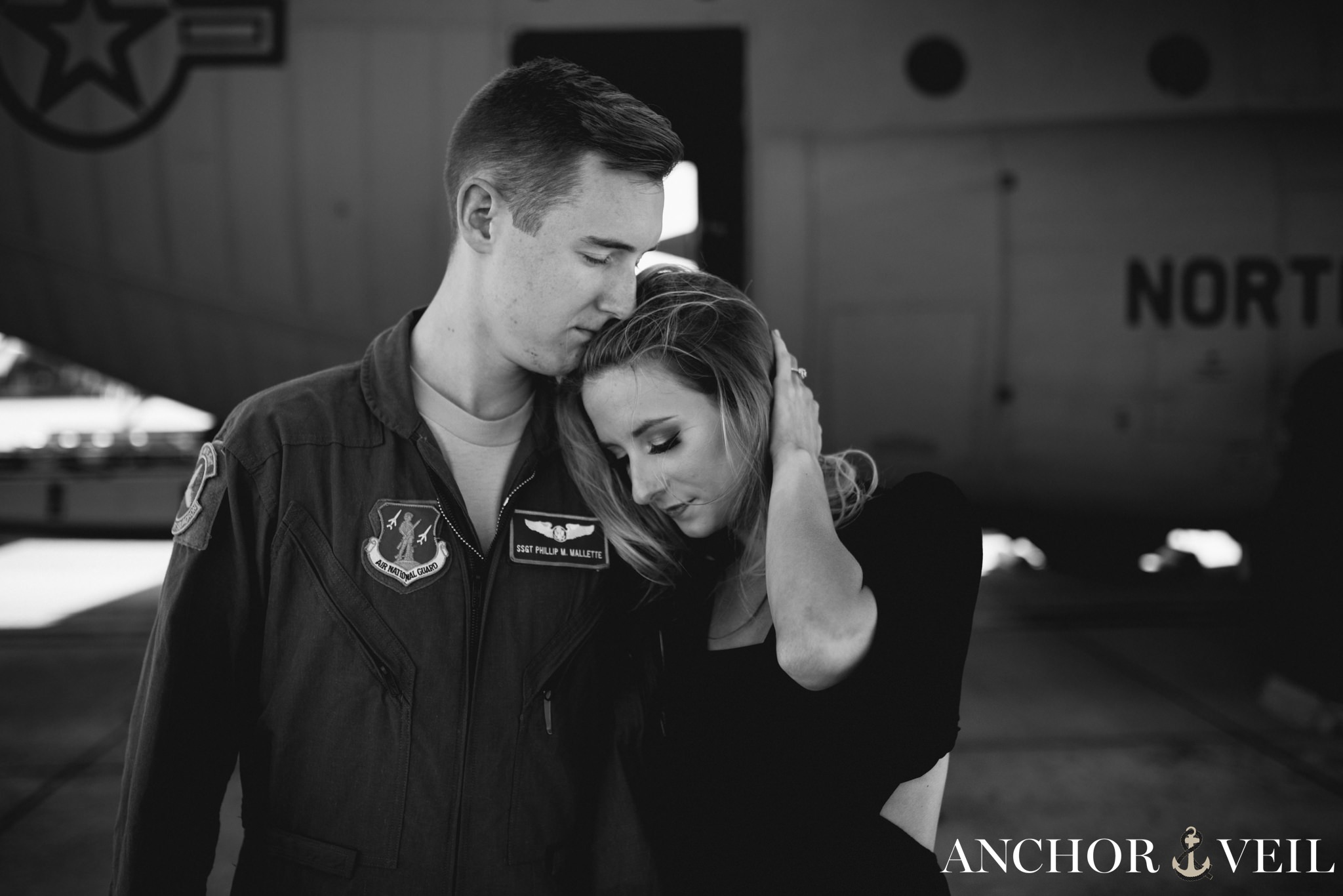 fixing her hair during the aviation themed engagement session in Charlotte NC