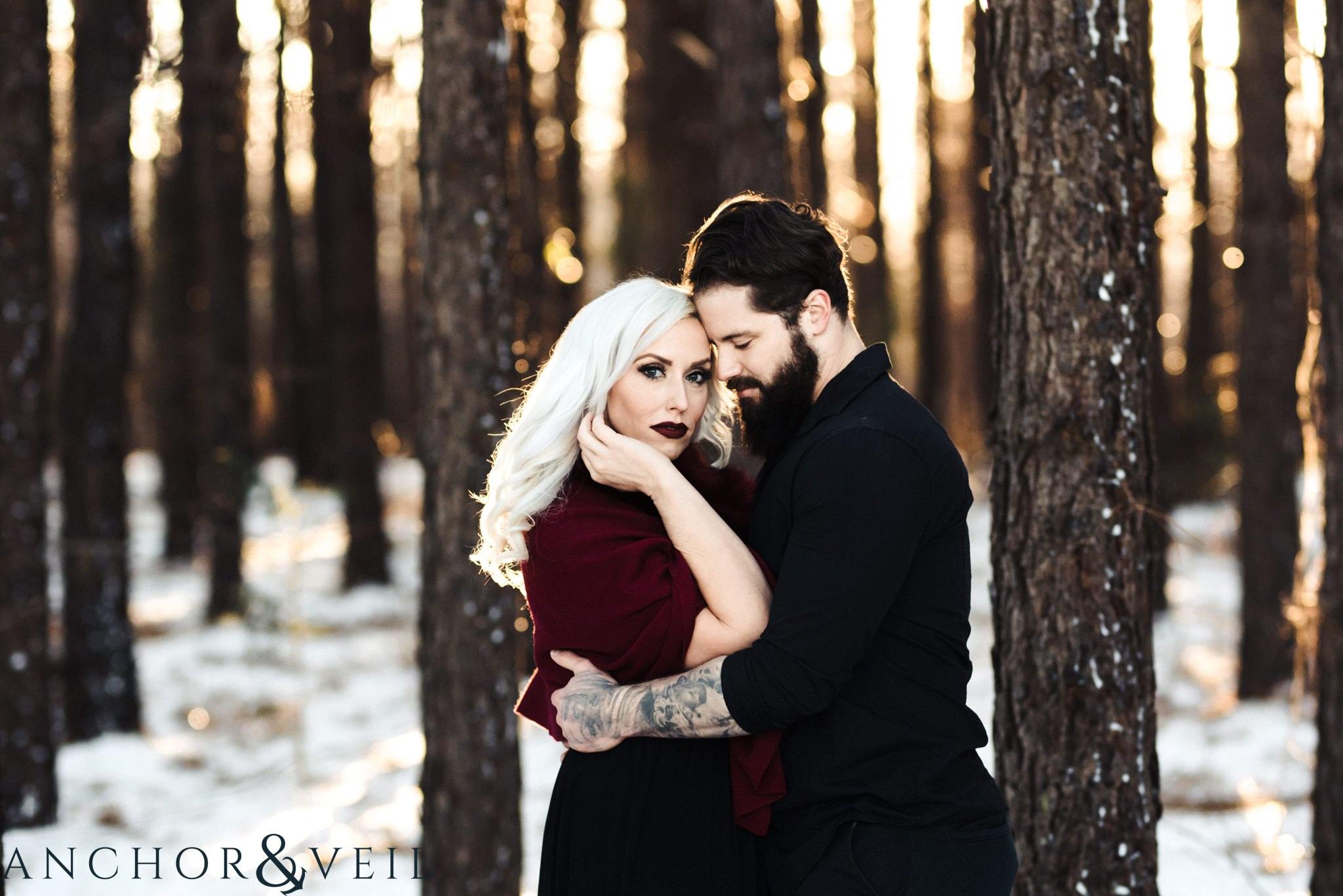 holding her hair during their charlotte snow engagement session