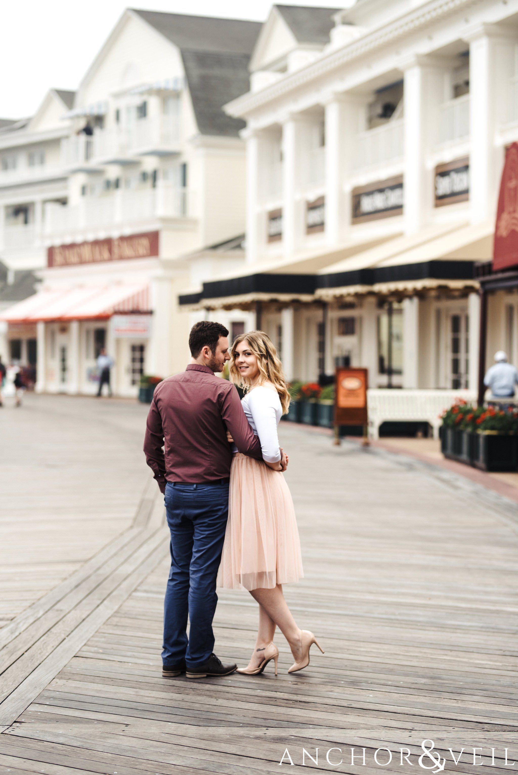 walking on the boardwalkduring their Disney world engagement session at the Boardwalk Hotel Inn