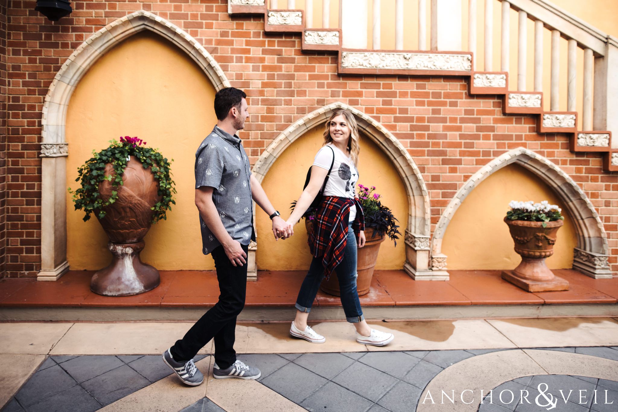 along the arches in Italy during their Disney world engagement session at Disney's Epcot