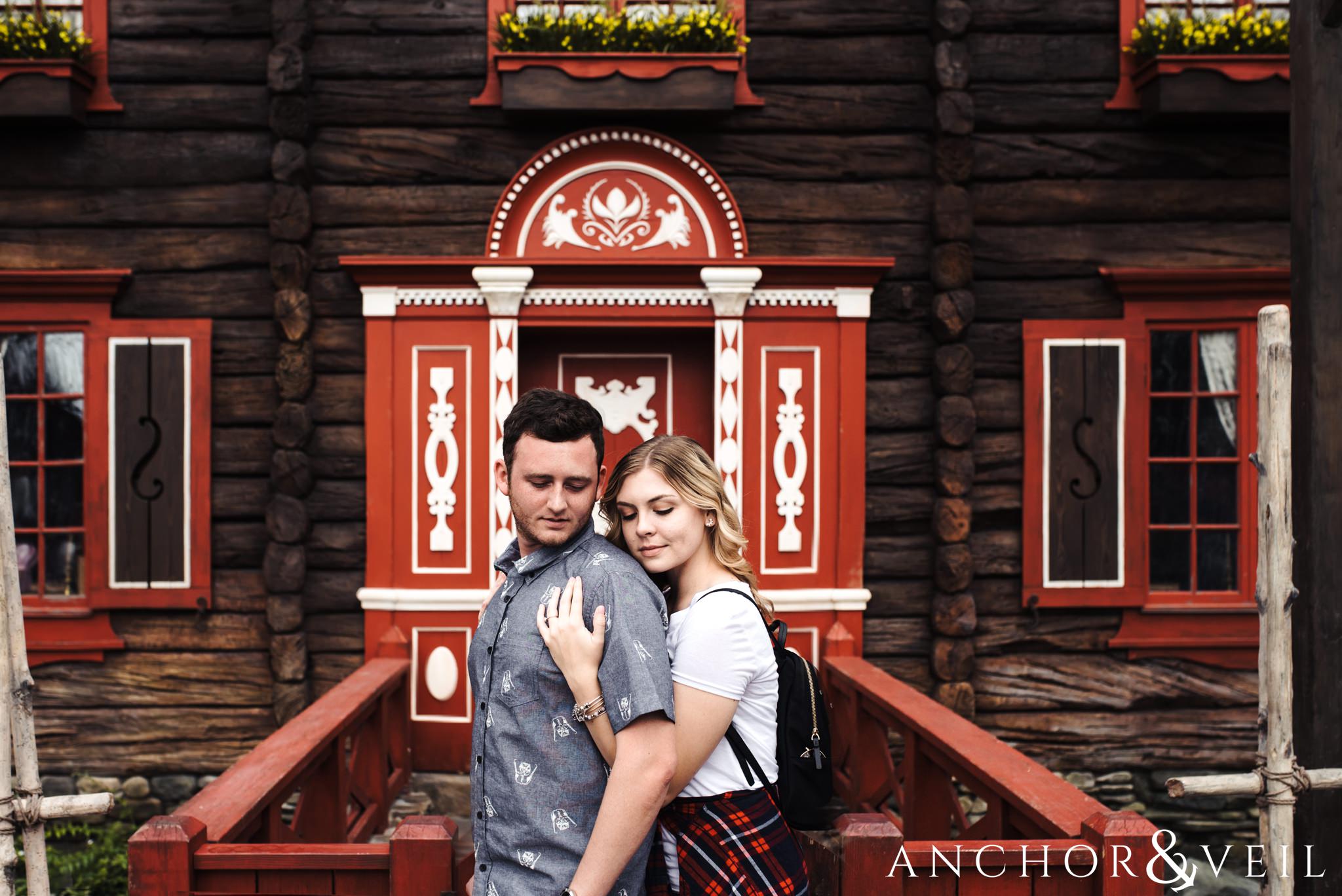 in front of the norway door during their Disney world engagement session at Disney's Epcot